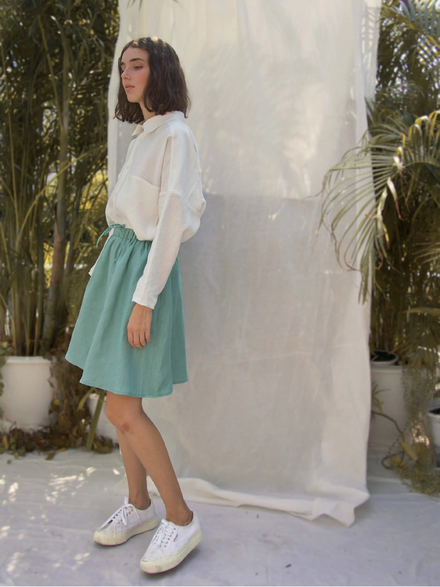 Lazy Skirt - model wearing skater length view with pockets in turquoise