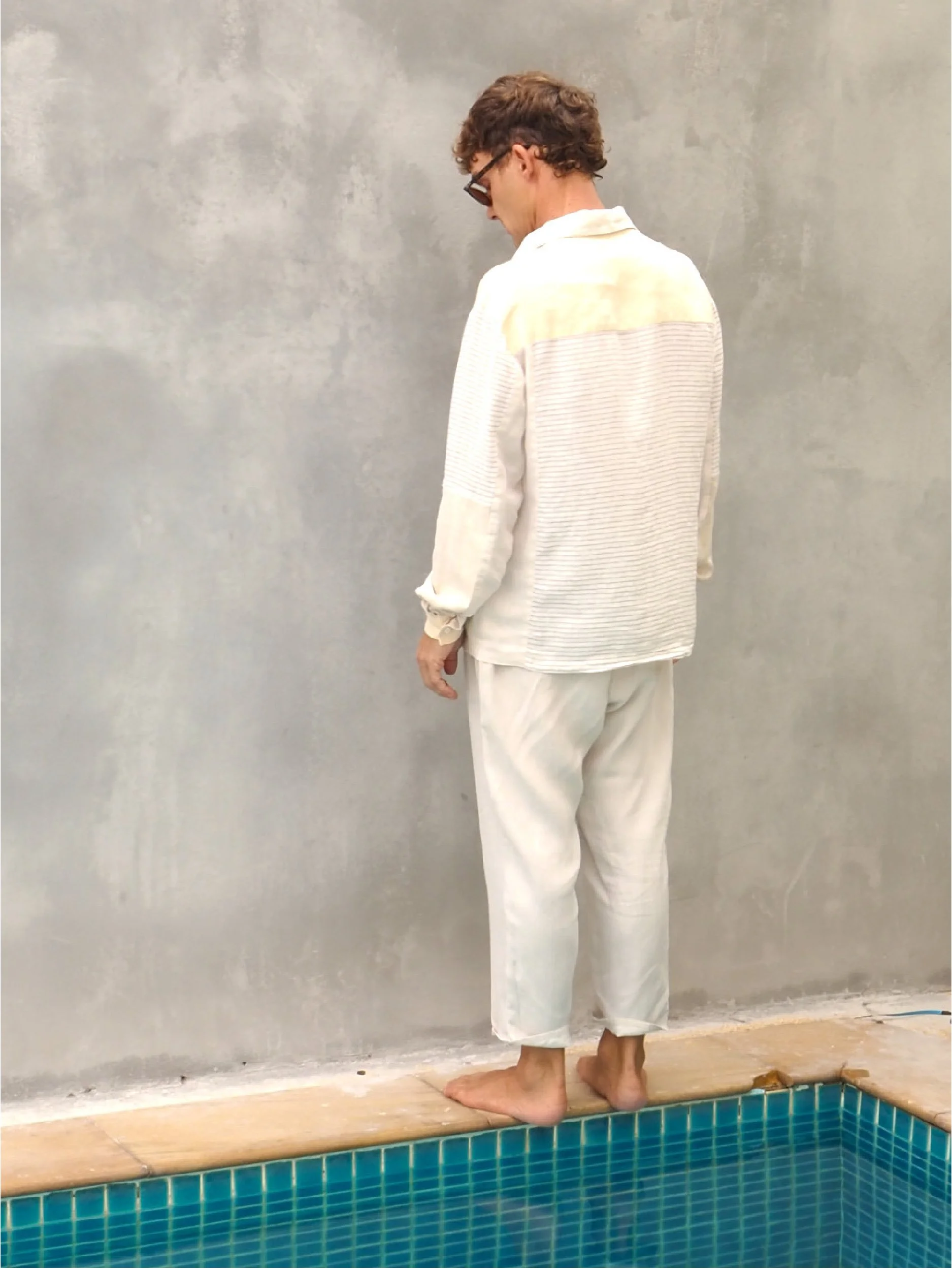 male model wearing adventure shirt - back view