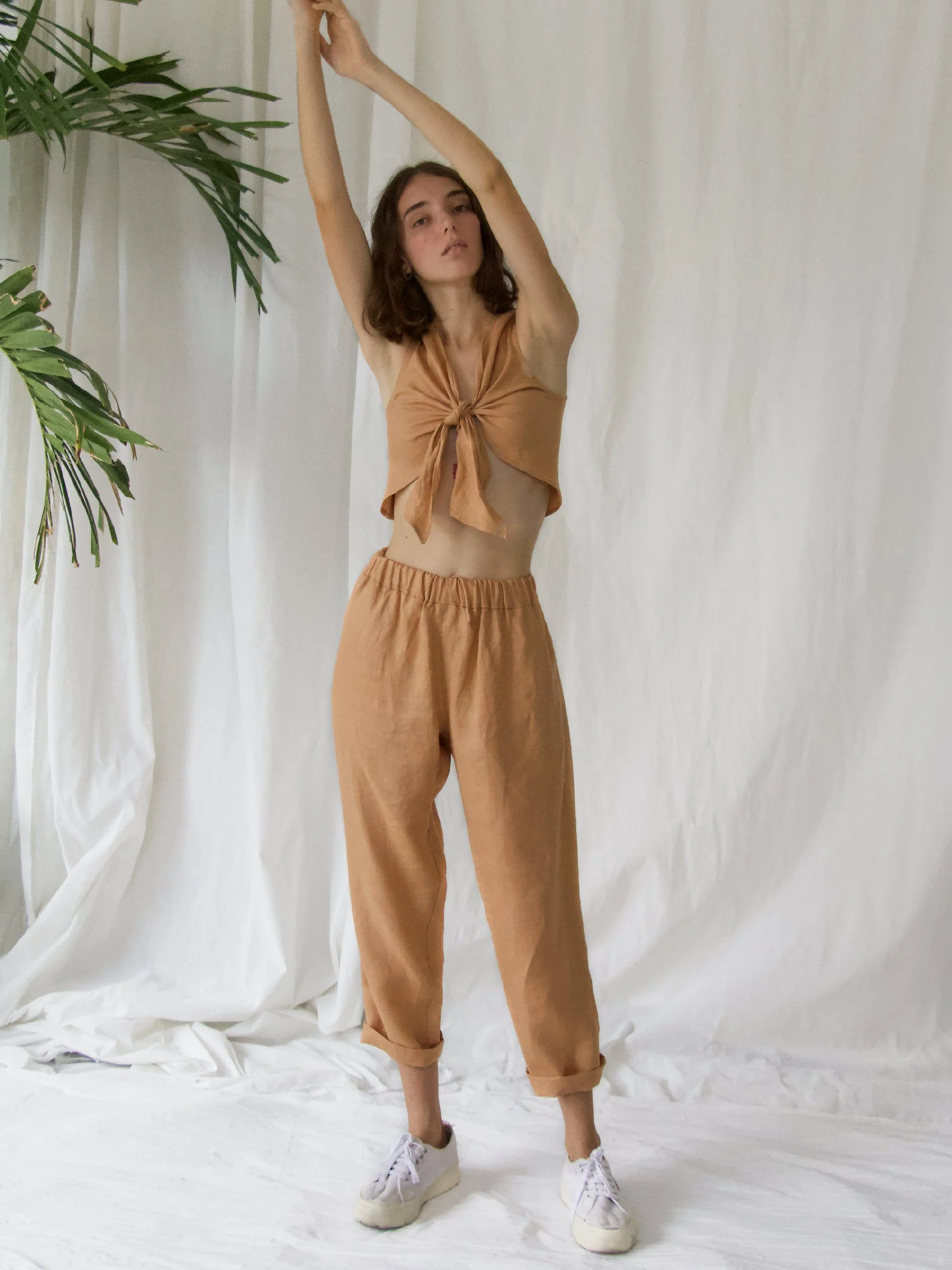 model wearing brown linen lazy pants and knot top