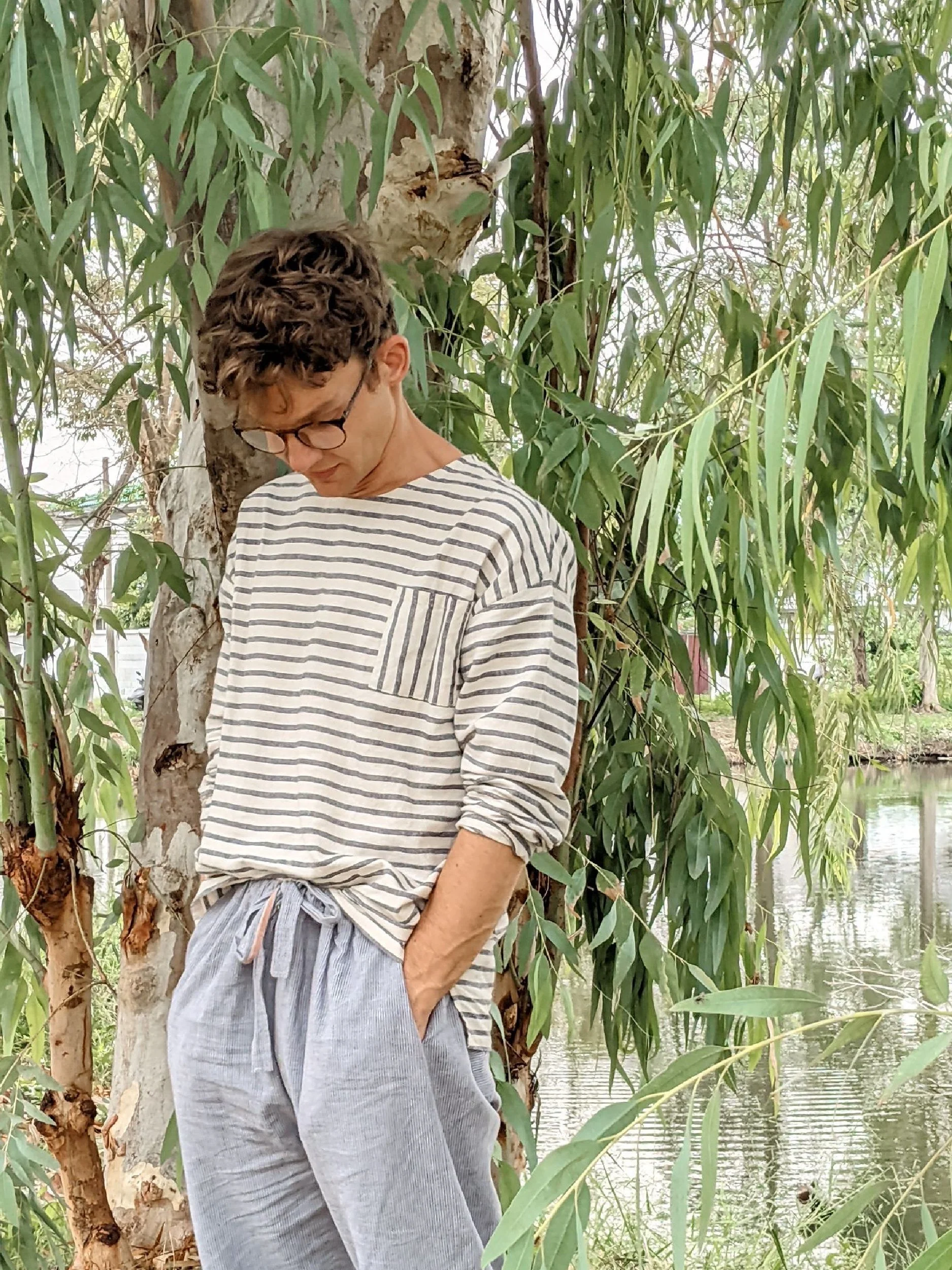 male model wearing a long sleeve view of the lazy top in a garden