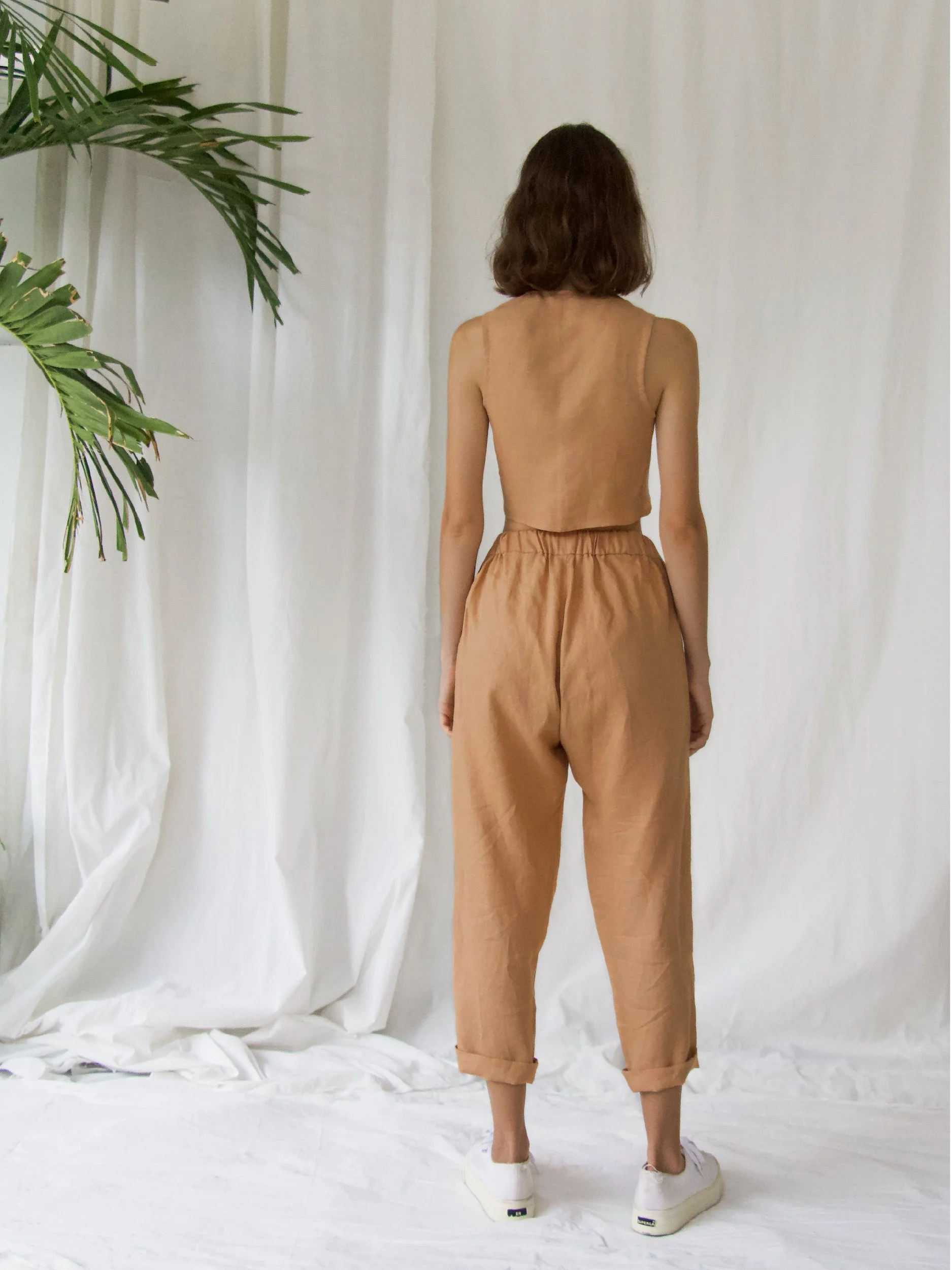 model wearing brown linen lazy pants - back view