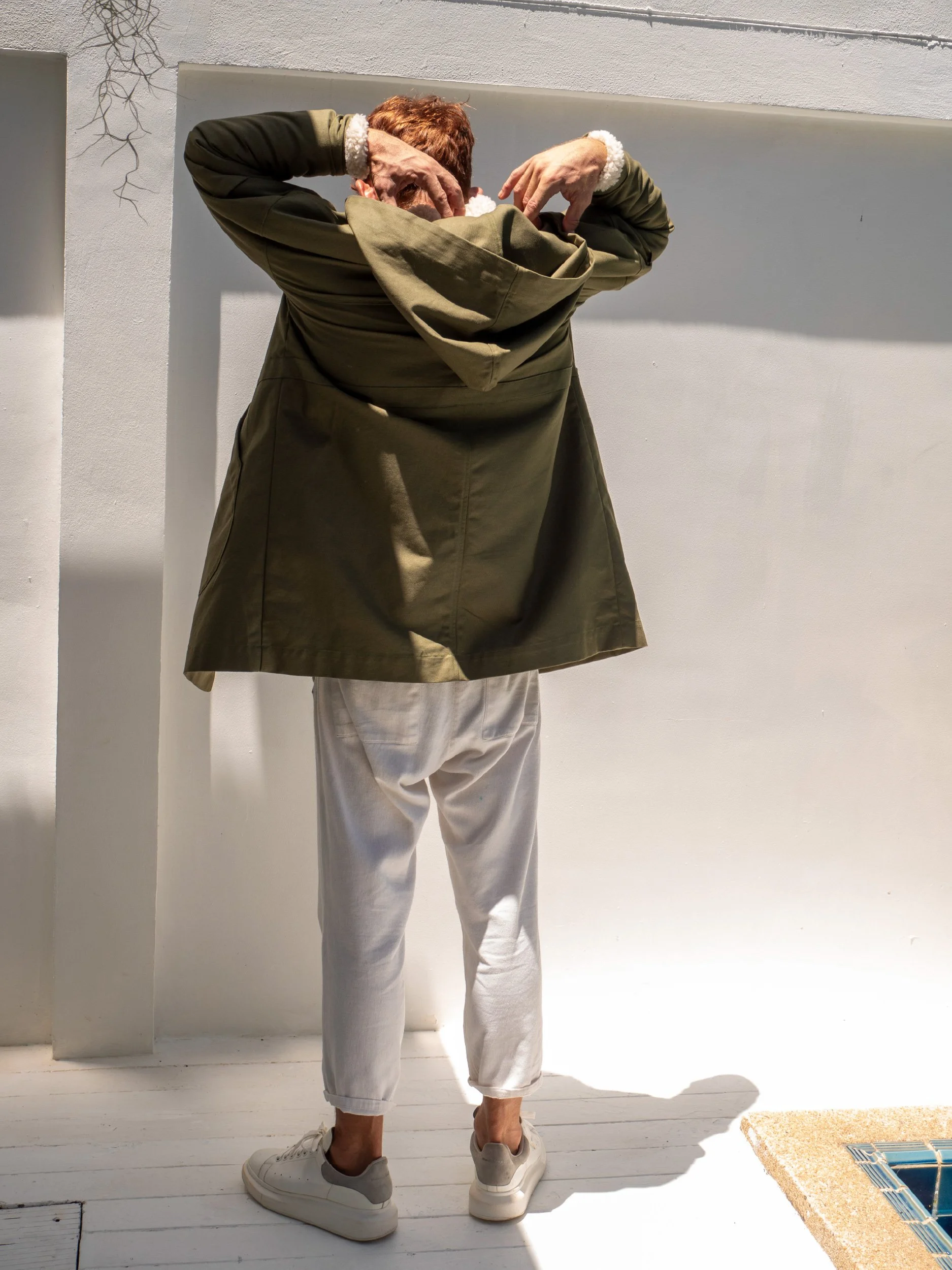 back view of green boxy parka with hood