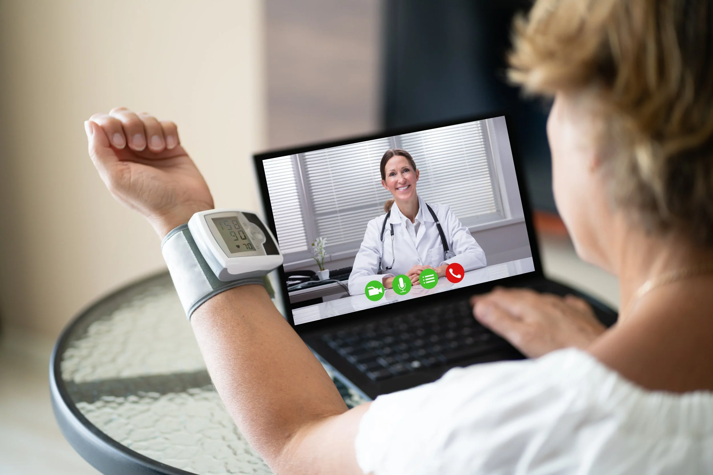 A woman in a rural community is at home getting healthcare with her local community hospital doctor through Telehealth services.