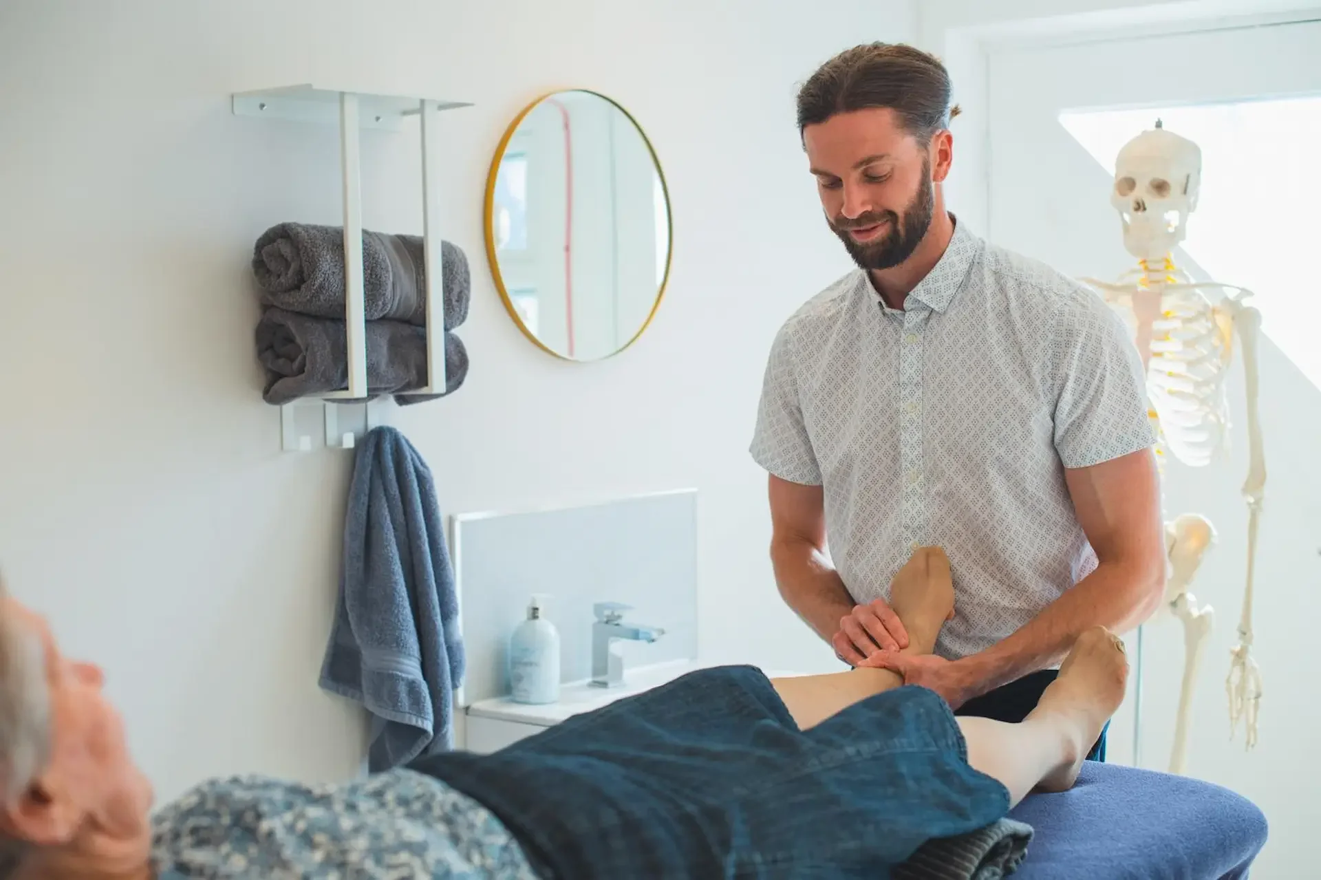 Josh Kelsall, registered osteopath, performing hands-on treatment at JMK Osteopathy clinic in Sheffield
