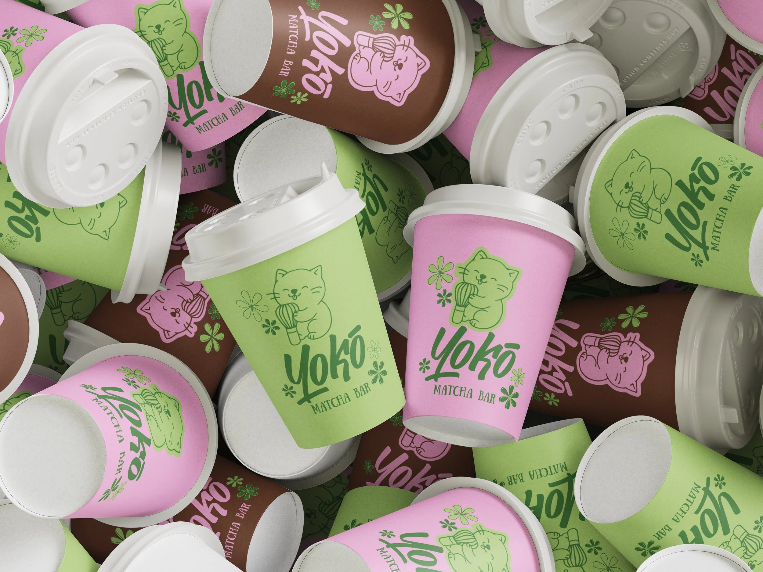 Pile of Yoko Matcha Bar disposable cups in pink, green, and brown. Each cup has a cartoon cat holding a matcha ice cream cone and the Yoko logo with flowers.