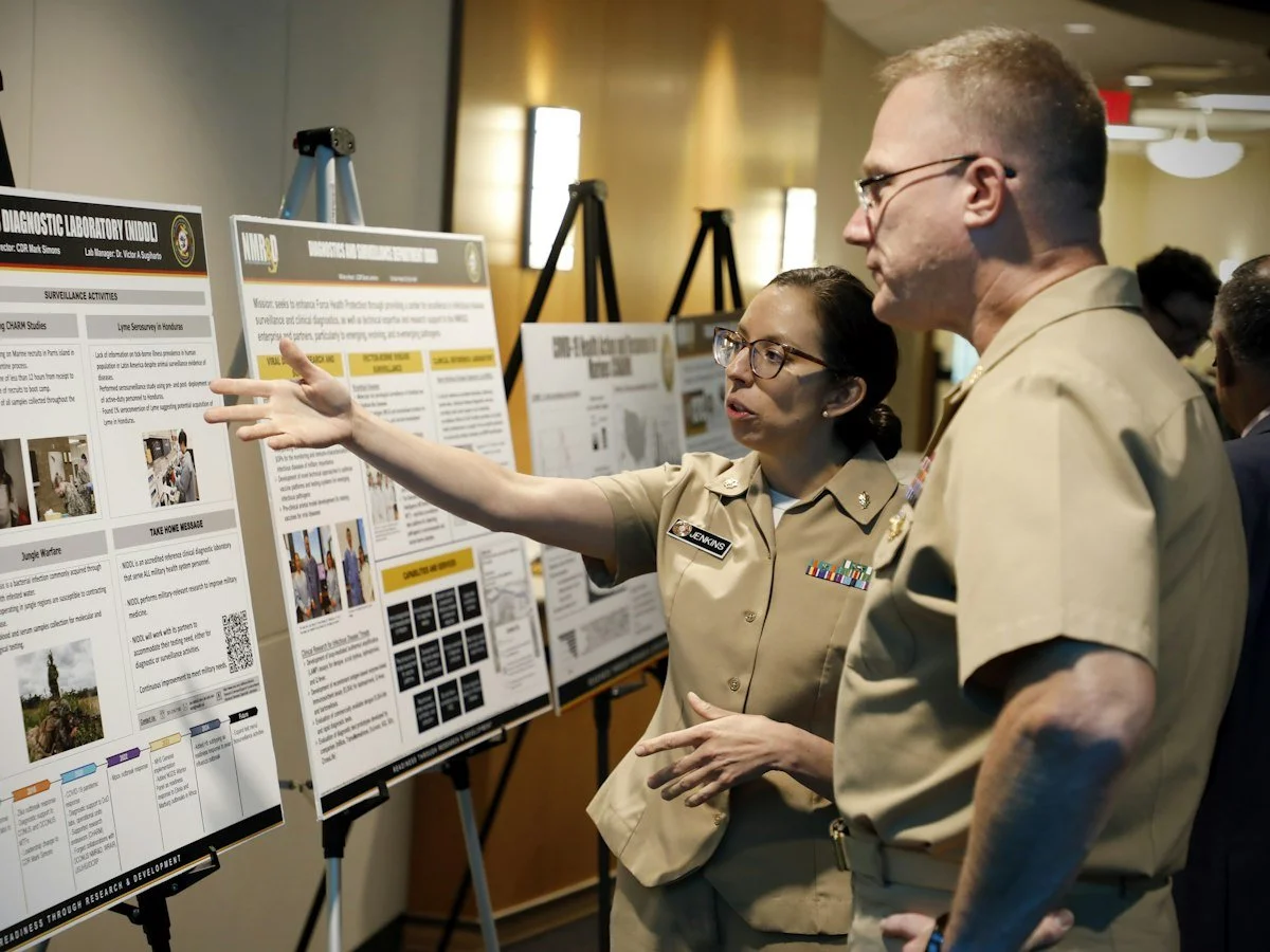 Delegates discussing research posters at a conference