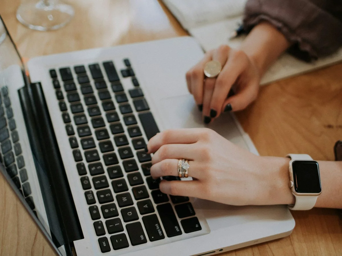 Writer typing website copy on a laptop