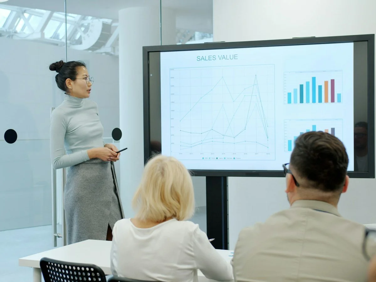 Speaker presenting data slides to a professional audience
