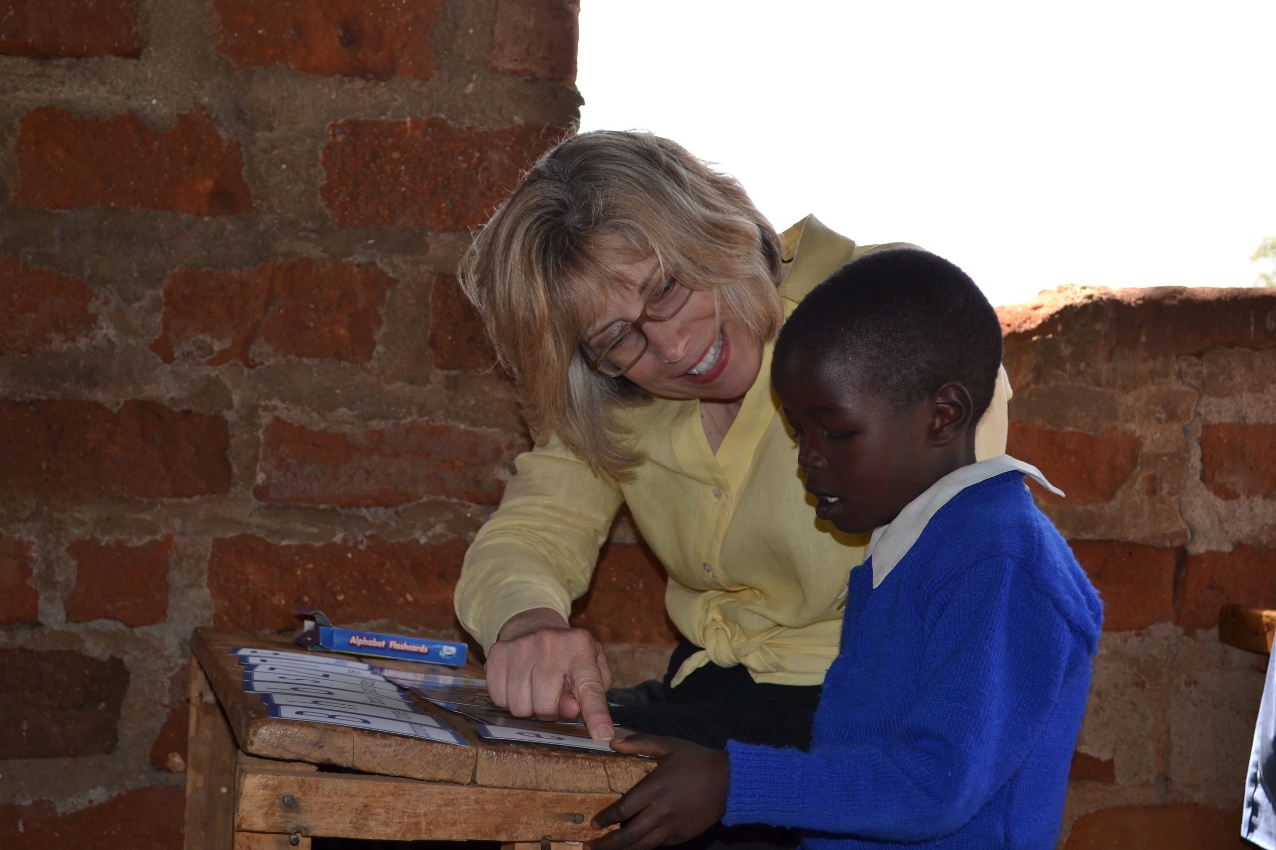 Joy Reading with child in Kenya.JPG