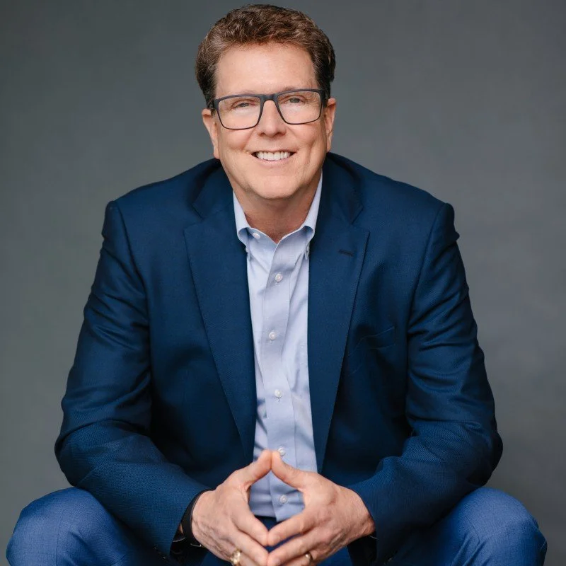 Profile picture of Dr. Tim Elmore wearing glasses, a blue shirt, and a navy blazer.