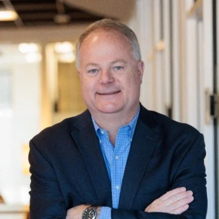 Headshot of Randy Hain with a blue shirt and black blazer.