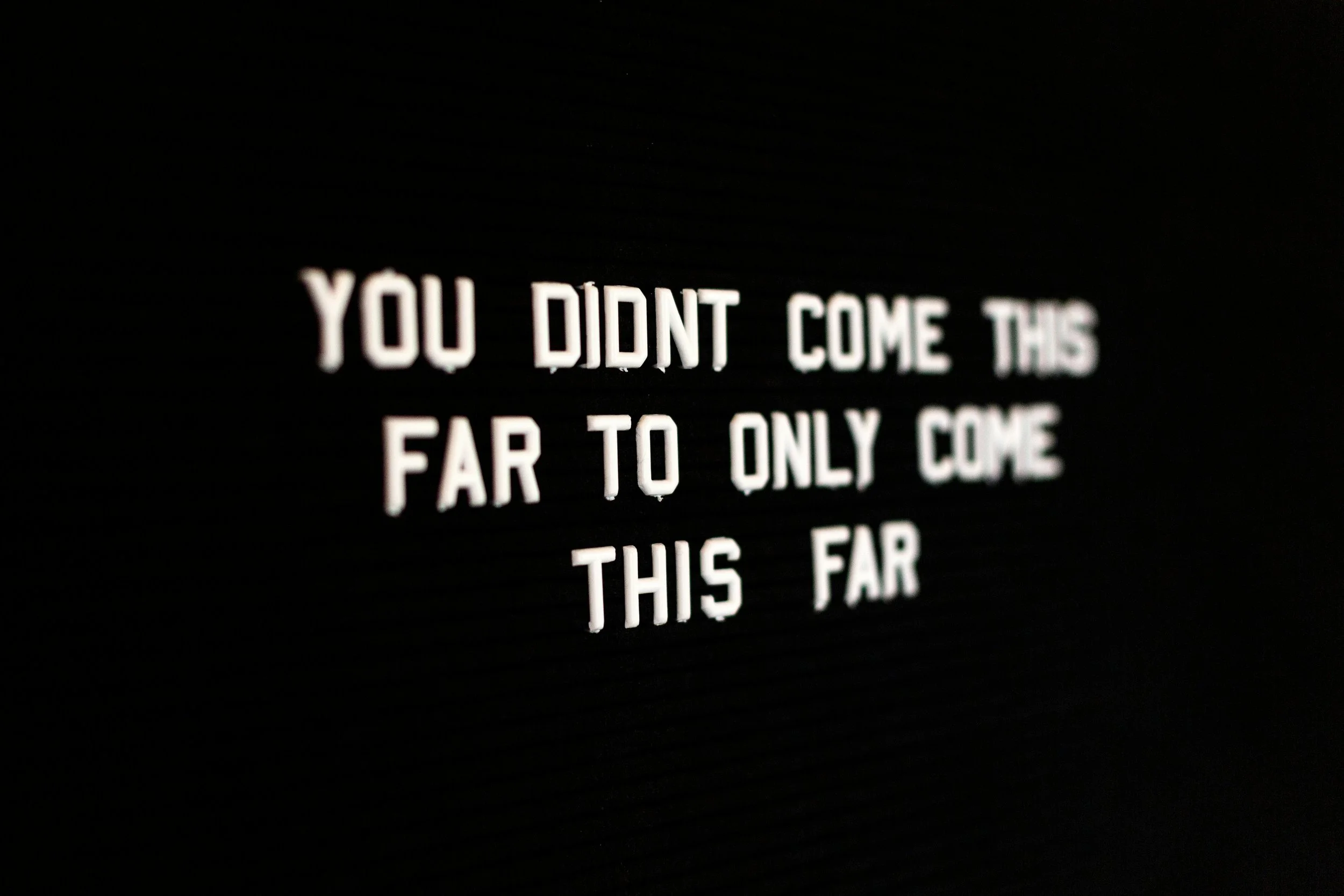 Quote on black background that reads, 'You didn't come this far to only come this far'.