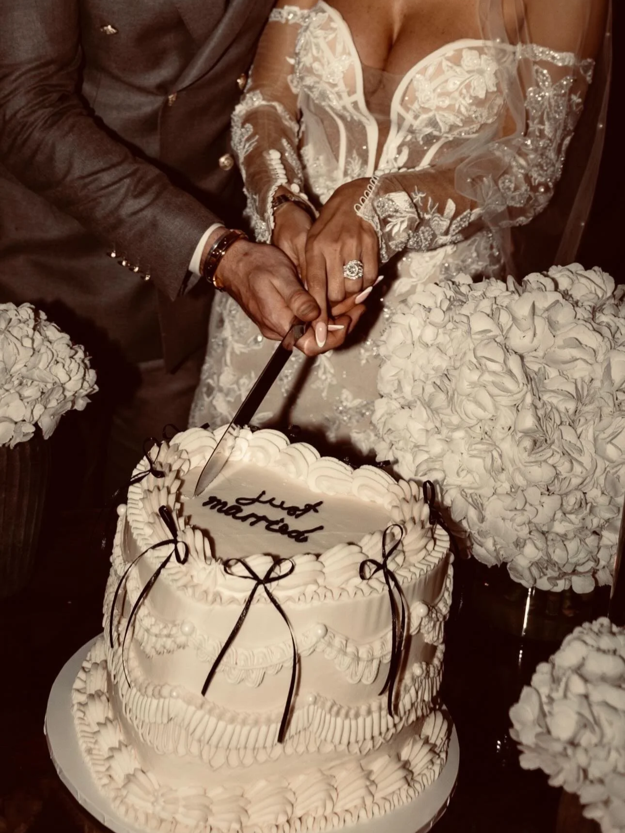 White heart shape wedding cake with black bows