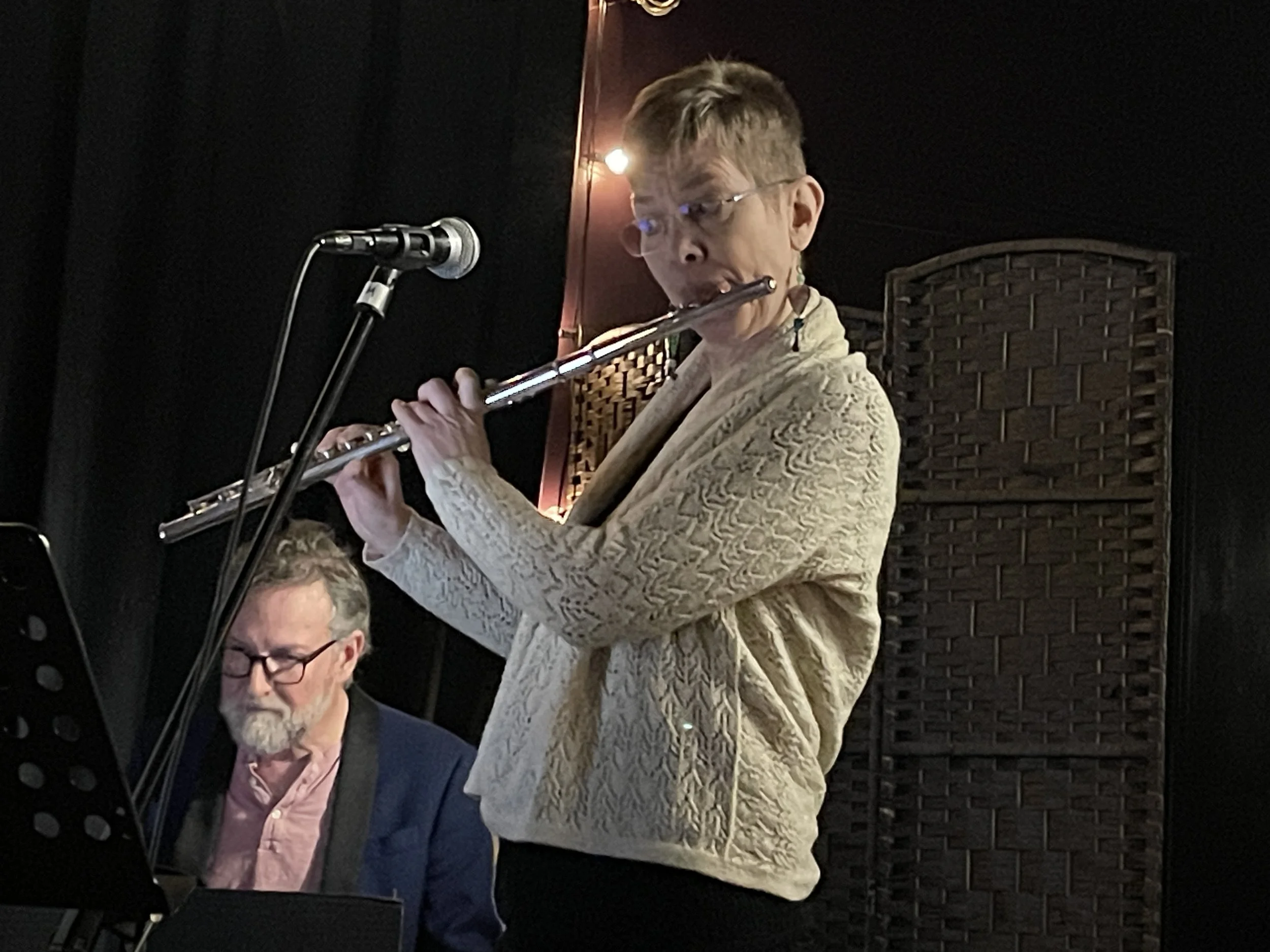 Annie Philips on flute, with Josh Sitron on piano behind.