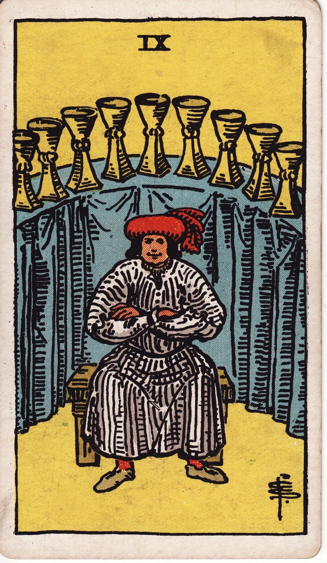 The Ten of Cups tarot card depicting a person sitting on a bench with arms crossed, a red hat, in front of a curtain with ten cups arranged in an arc.