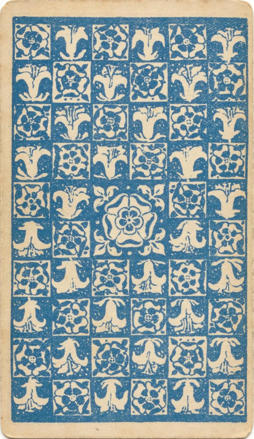 A decorative tile pattern with floral and abstract designs in blue and white, arranged in a grid with a central floral motif.