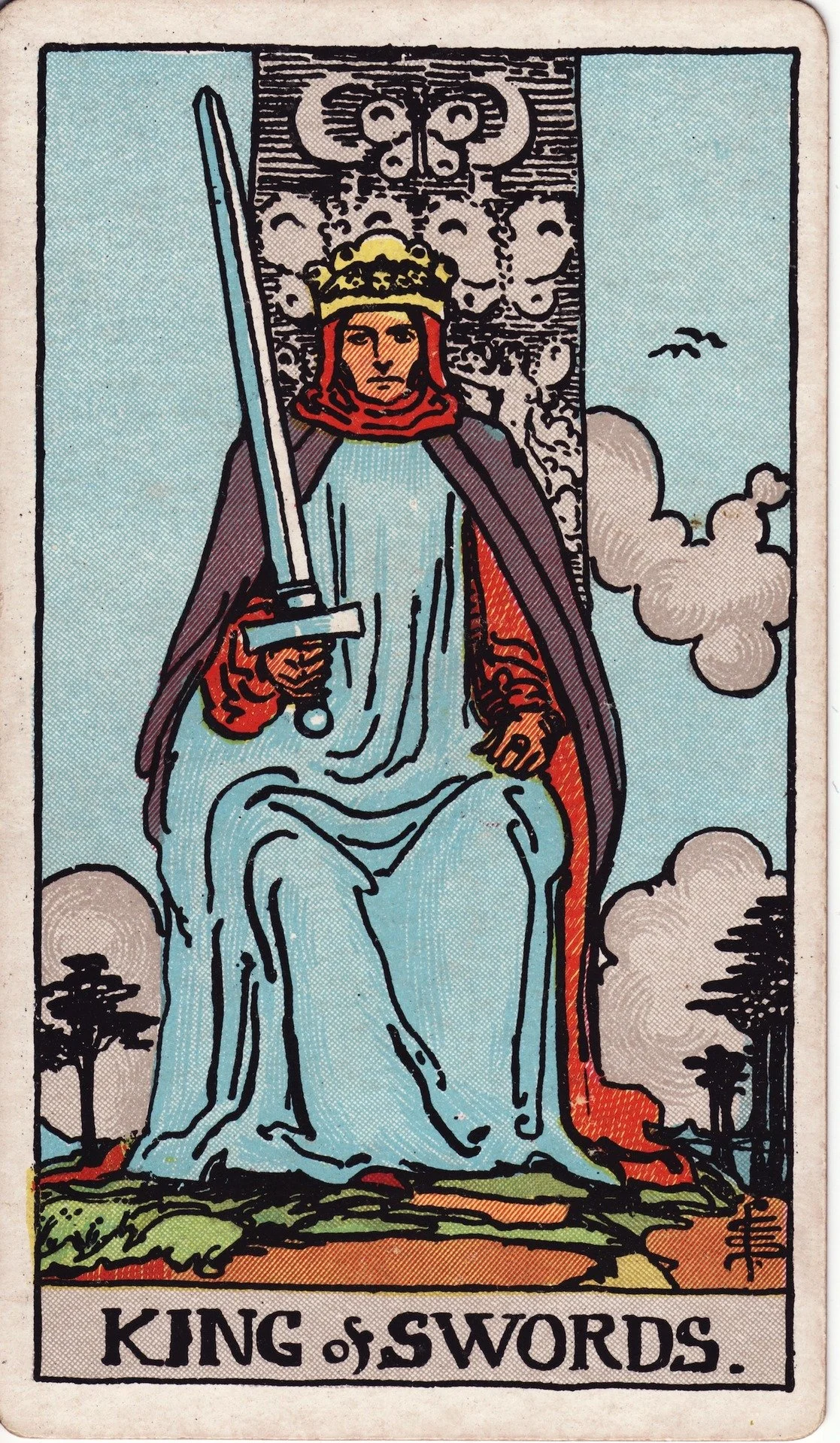 The tarot card 'King of Swords' depicts a seated king holding a sword, wearing a crown and cape, with clouds and a cloudy sky background.