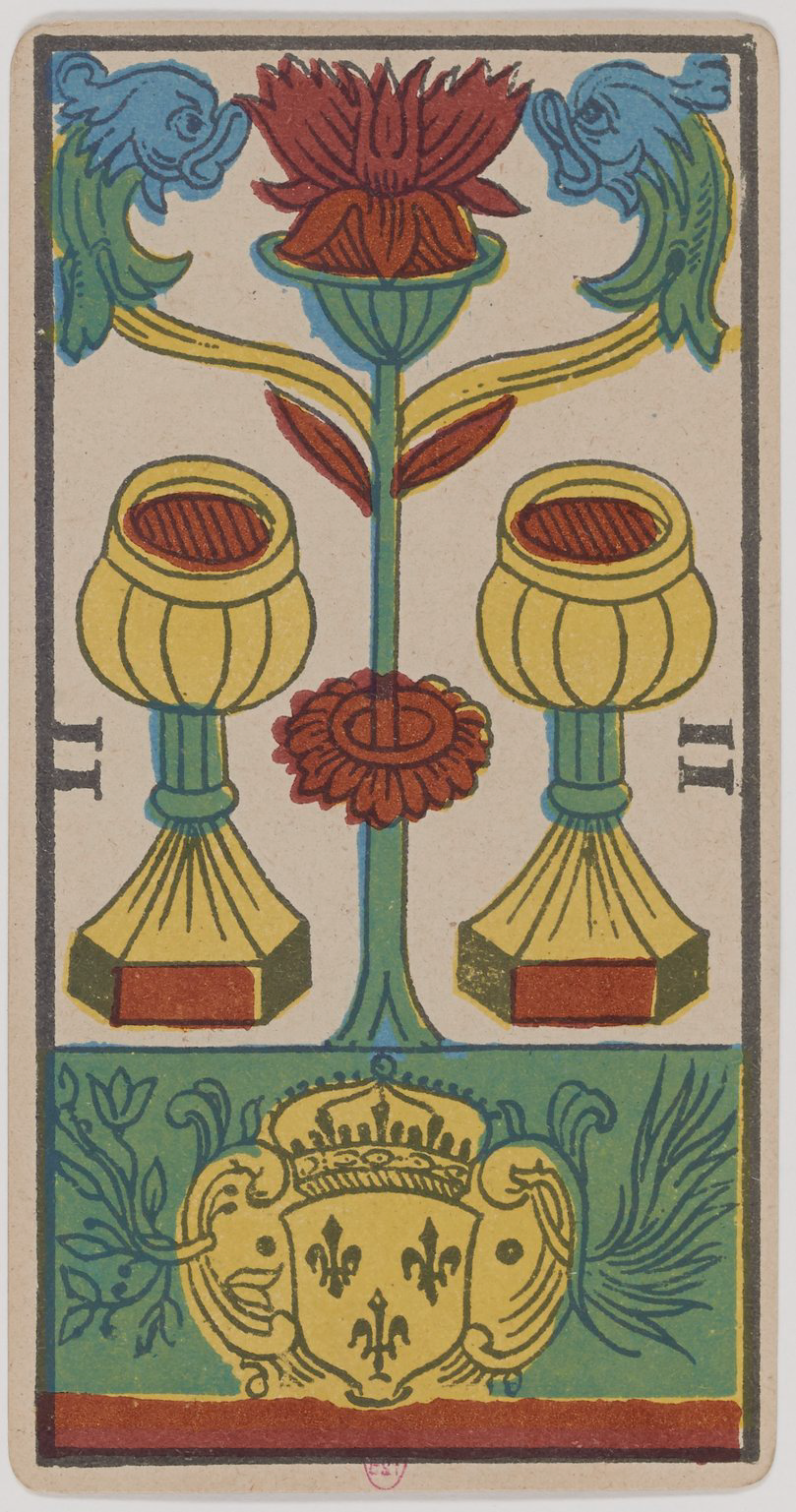A colorful tarot card illustration featuring a central red flower with blue and green dragon-like creatures at the top, two yellow lamps or chalices on either side, and a shield with three fleur-de-lis symbols at the bottom. The background is divided into sections of green, red, and beige.