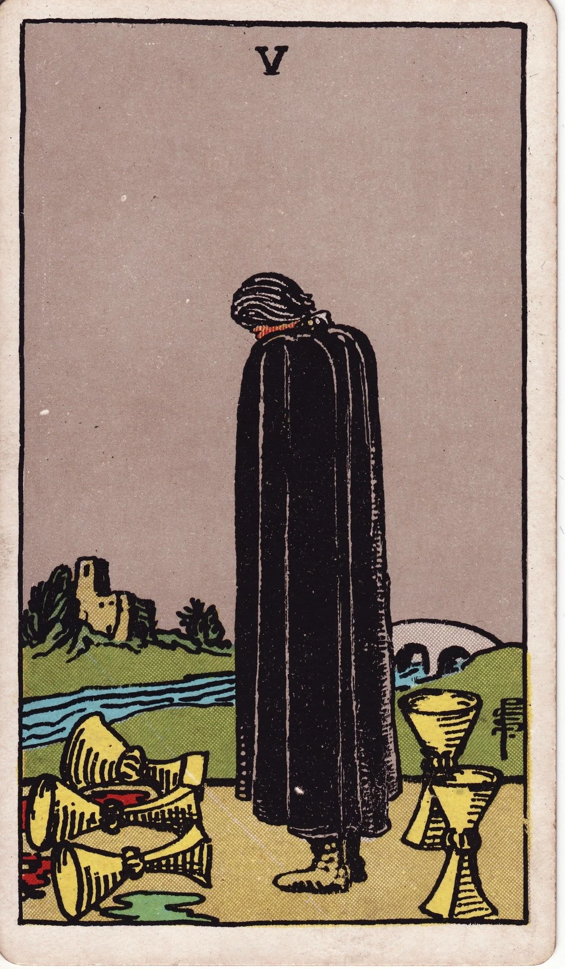 The Five of Cups tarot card showing a person in a black cloak looking at three spilled cups and two standing cups behind them, with a river, a bridge, and a ruined castle in the background.