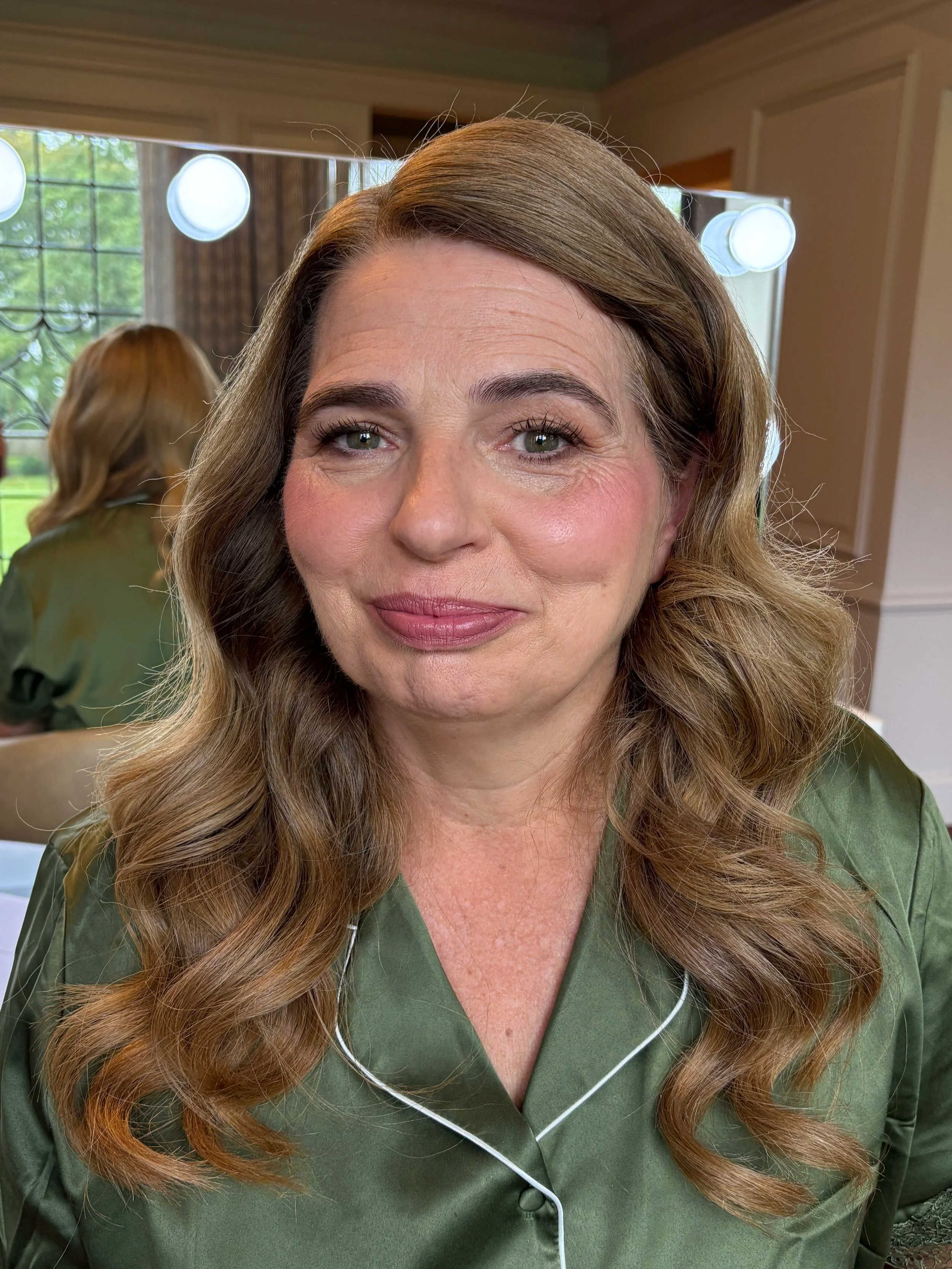 Beautiful mother of the groom makeup with pink lips and cheeks