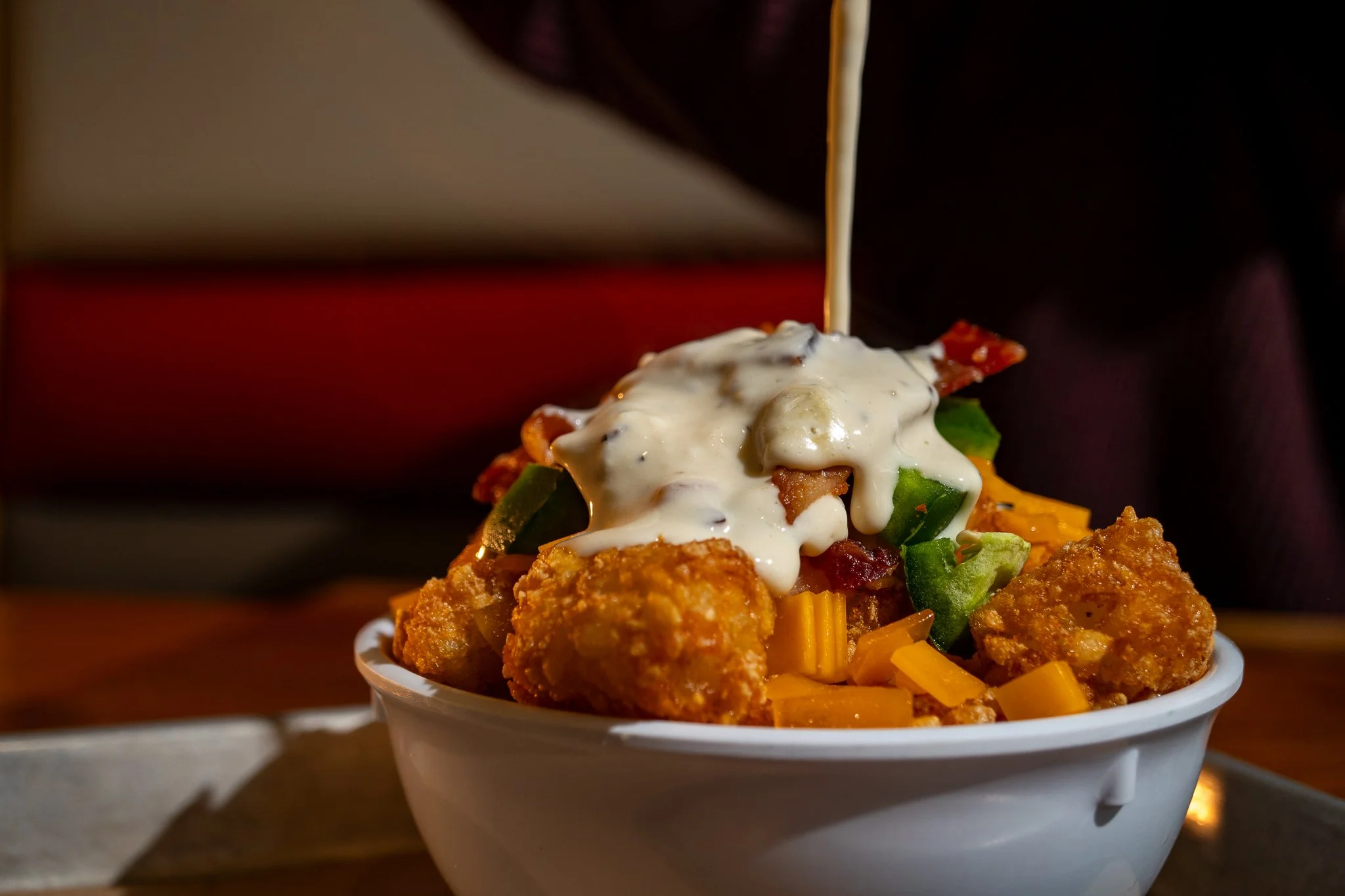 Bowl of Zeps EPIQ tater tots and house-made cheese sauce