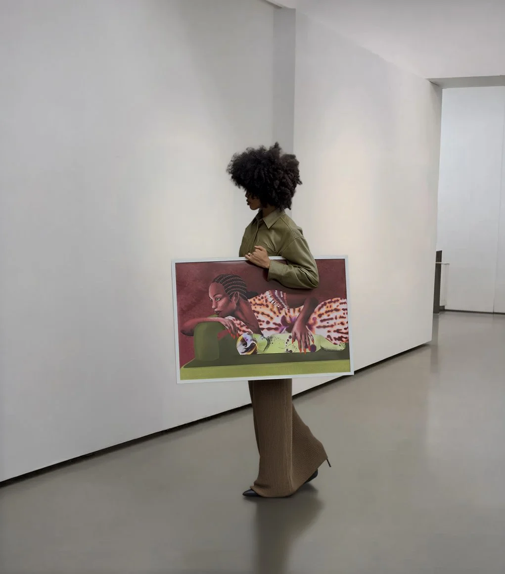 A woman with curly hair carrying an art print of a woman with braided hair, leopard print clothing, and red nail polish, in a gallery or museum with minimalist white walls and gray flooring.