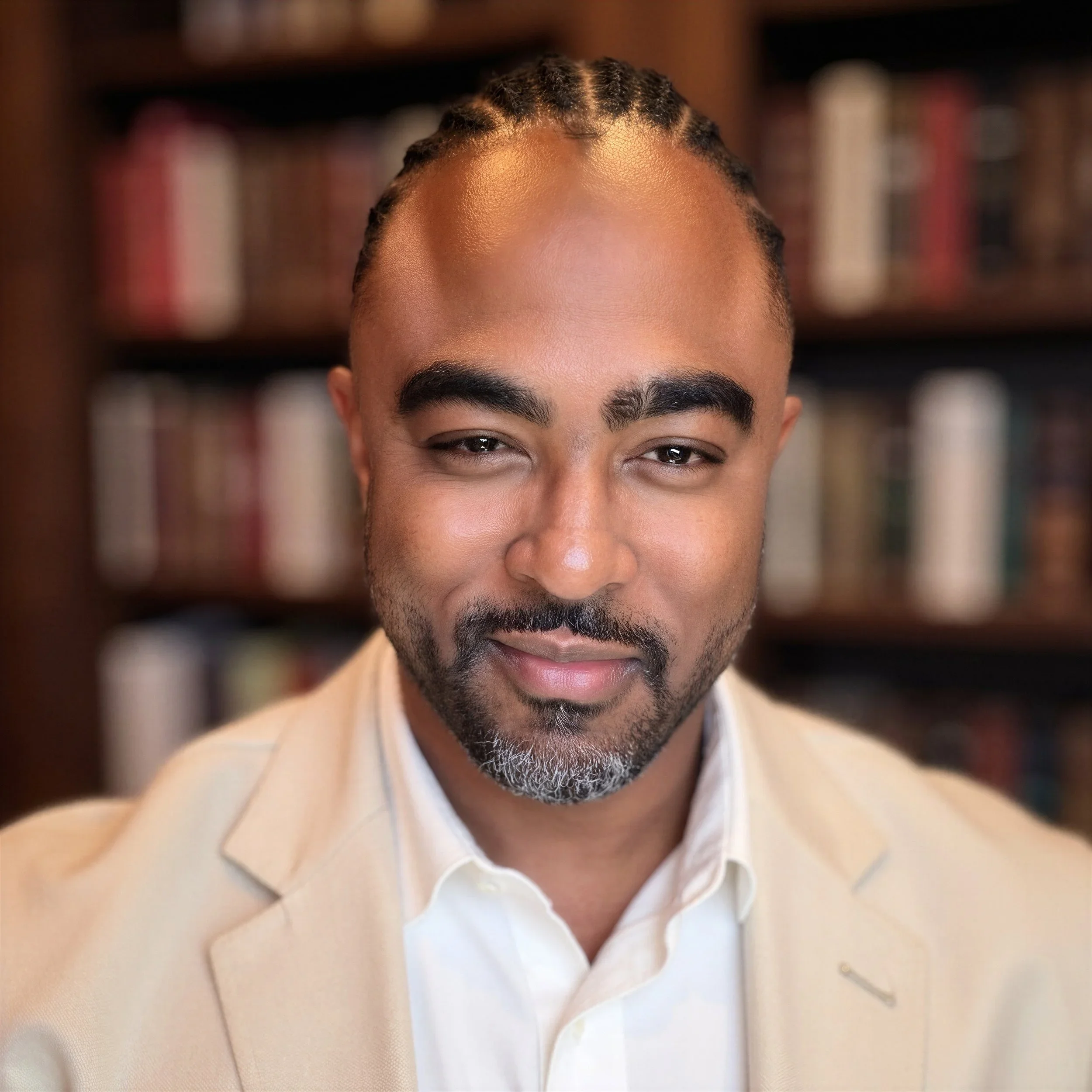Display of various small guitars hanging on a wall in a music store, colorful and arranged in rows.