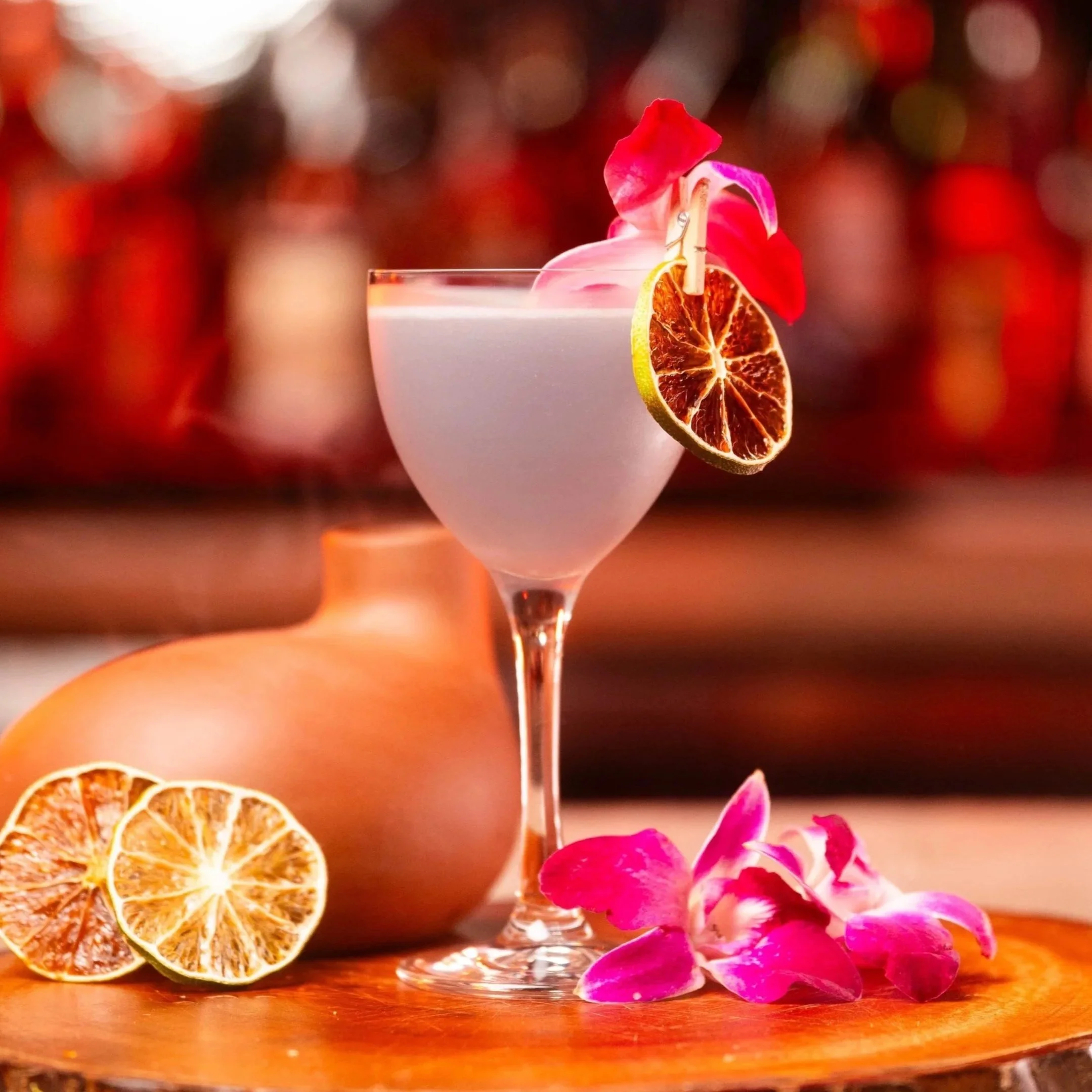 A violet tequila drink with flower