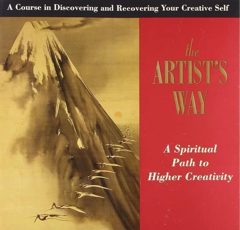 Book cover titled 'The Artist's Way: A Spiritual Path to Higher Creativity' with an illustration of a mountain, birds flying, and the sun in the background.