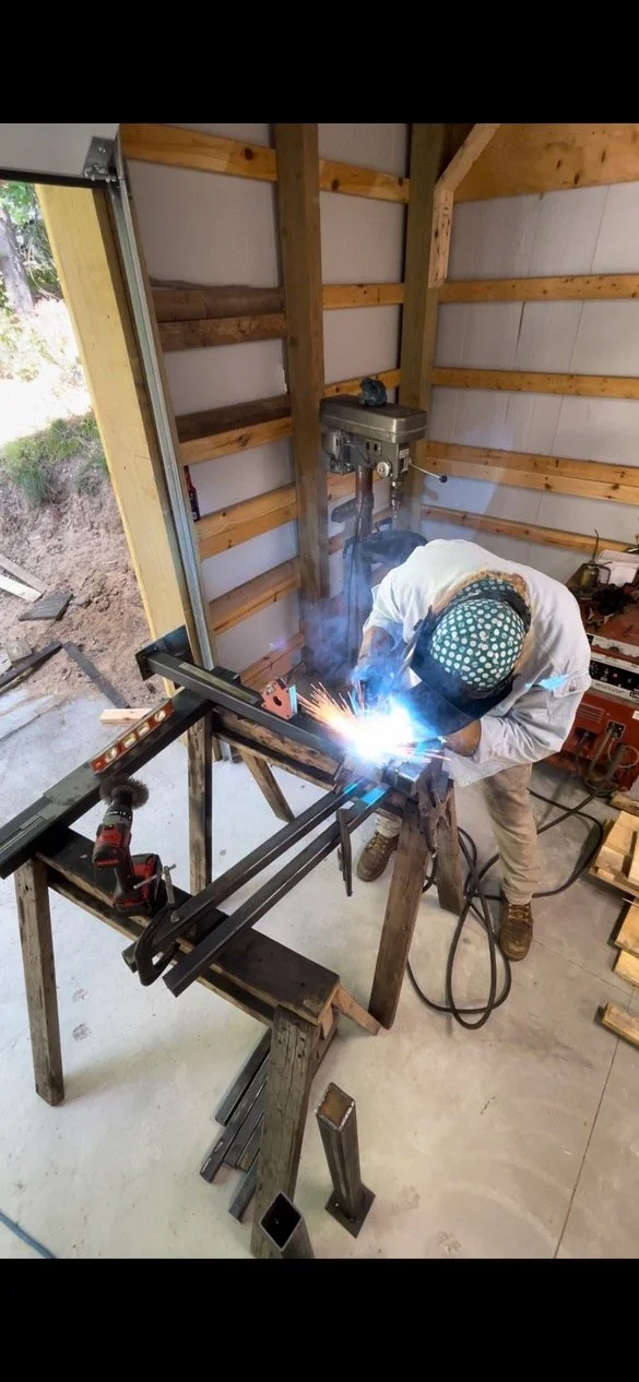 Person welding a custom handrail in Traverse City, Michigan.