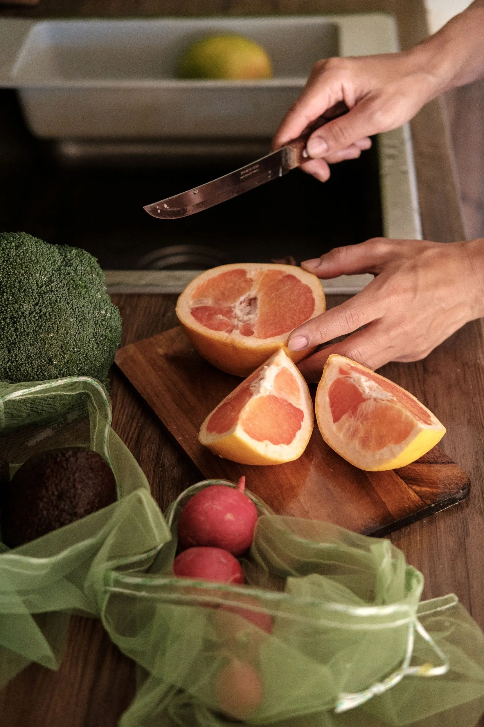 Woman slicing a blood orange to create balanced fruit pairings for better blood sugar control