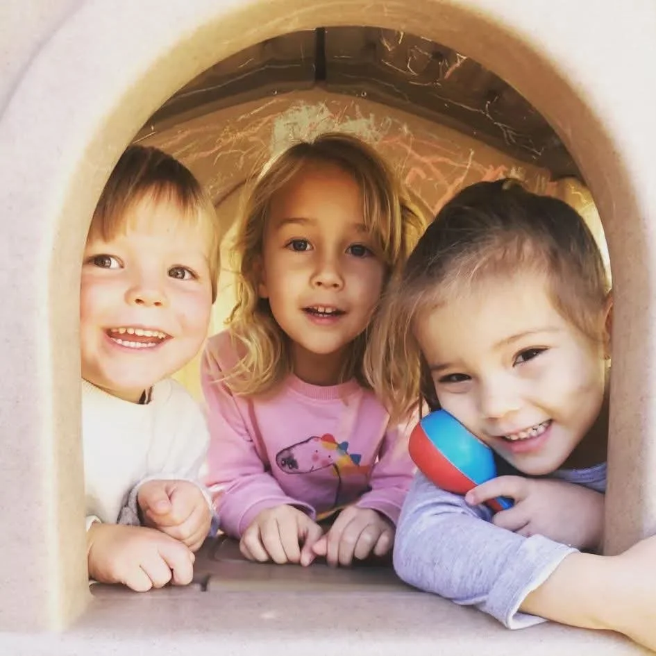 three children playing in arch in new Orleans nursery school