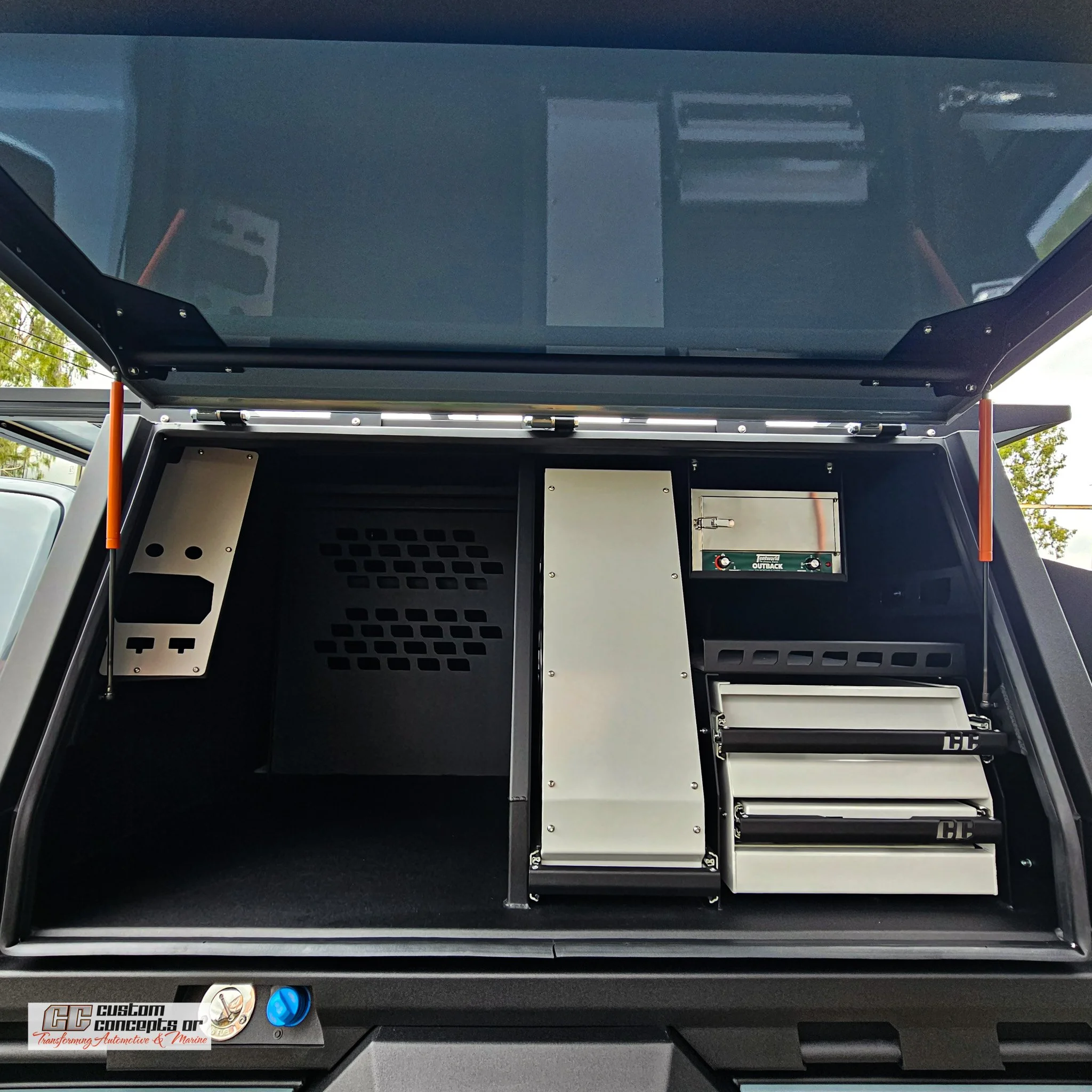 Custom shelving layout inside a Ford Ranger Super Duty canopy providing organised storage for tools and touring equipment.