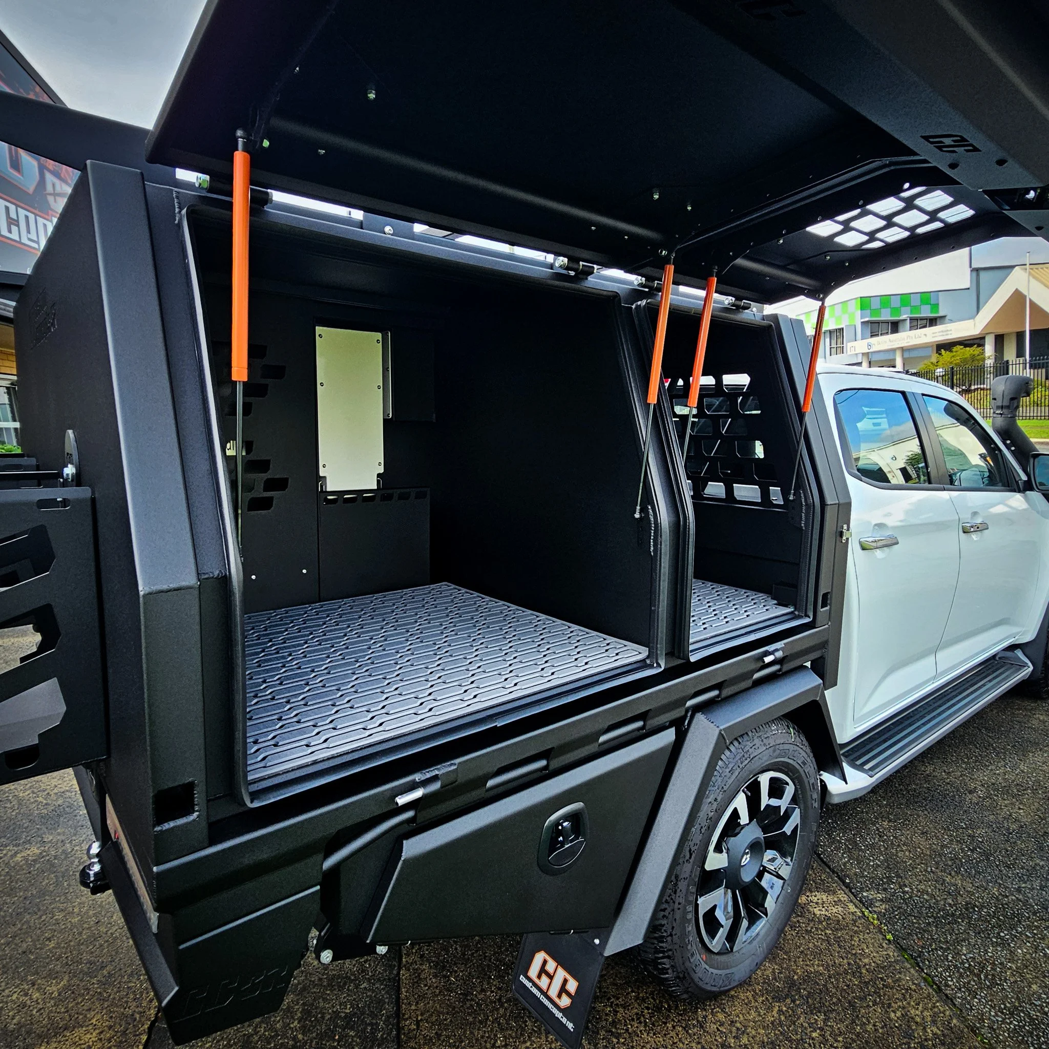 Open side access compartments inside custom Mazda BT-50 aluminium canopy featuring LED lighting and modular storage space.