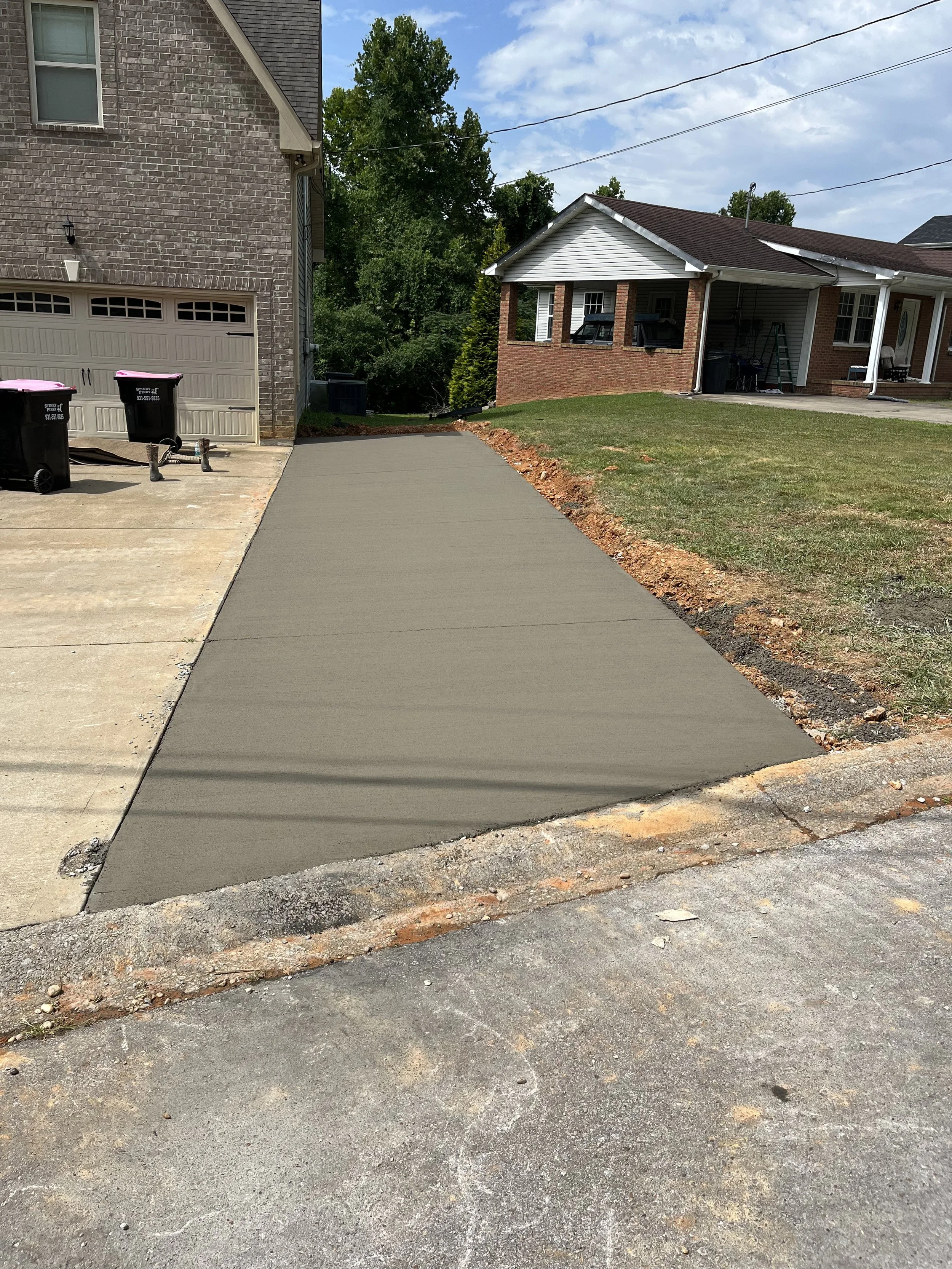 Seamless extension of an existing concrete driveway, providing extra parking space while maintaining a uniform look with the original design.