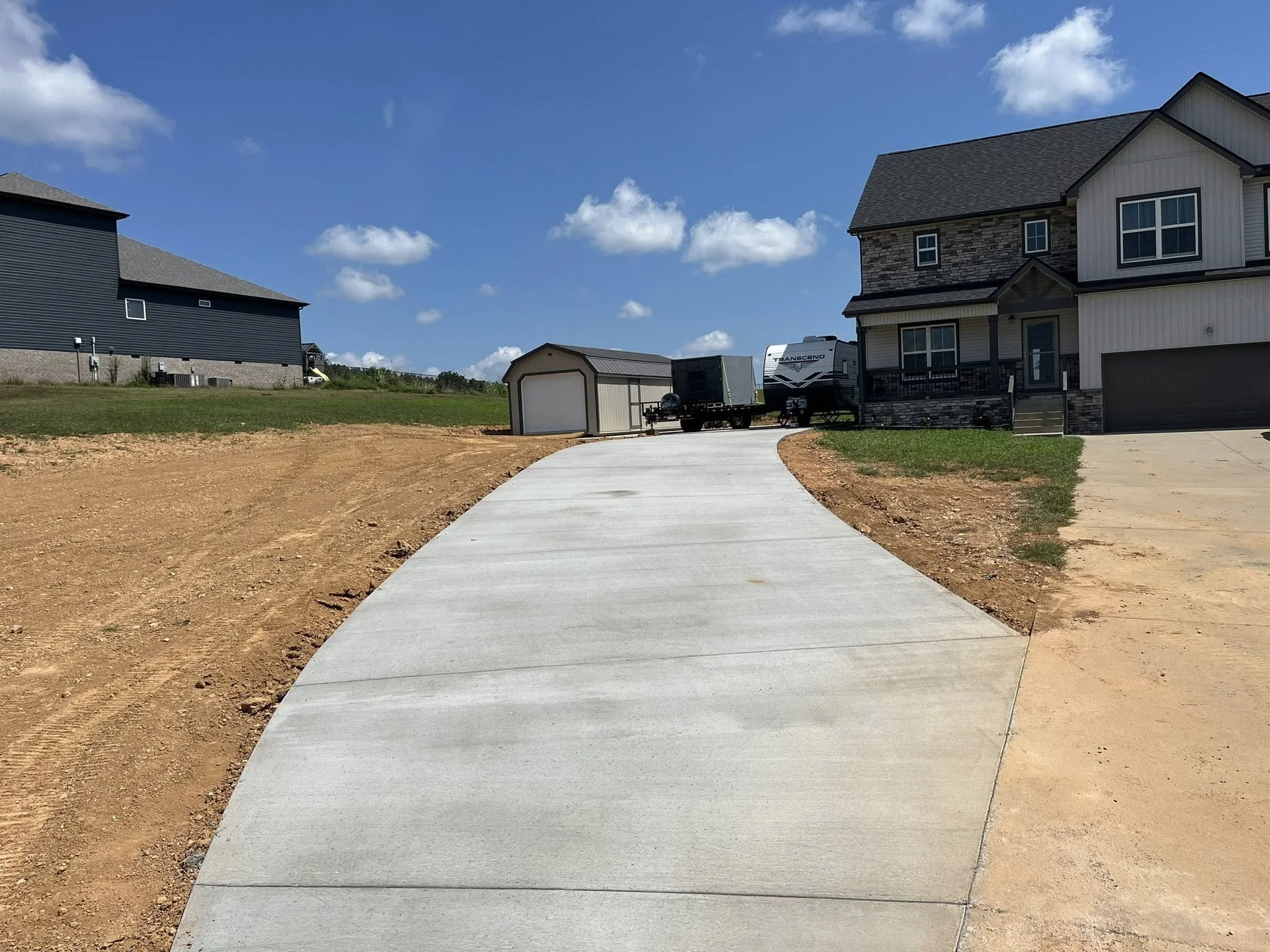 Installation of an additional concrete driveway, front view.