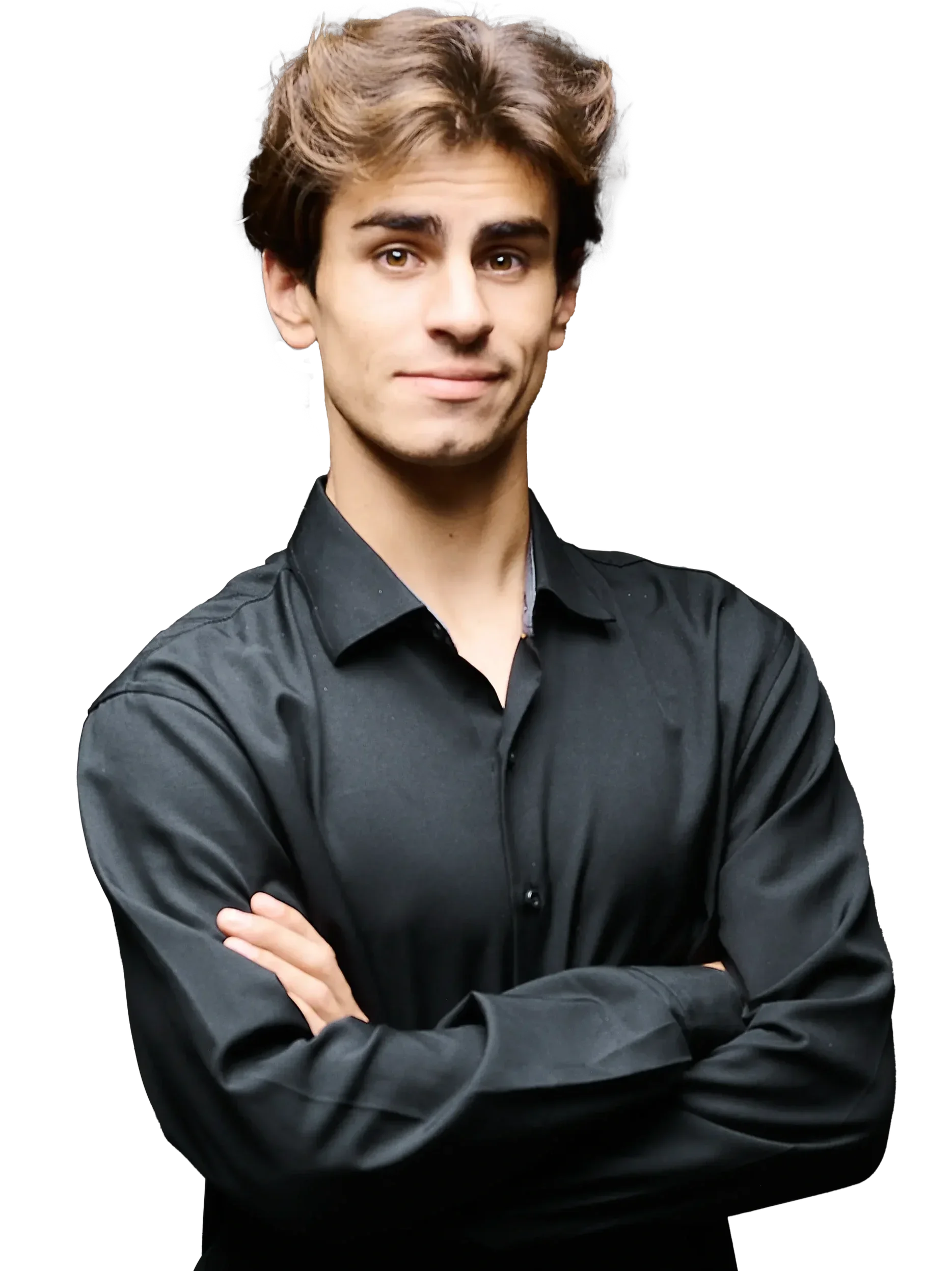 A young man with brown hair and a slight smile, wearing a black button-up shirt with his arms crossed, standing against a black background.