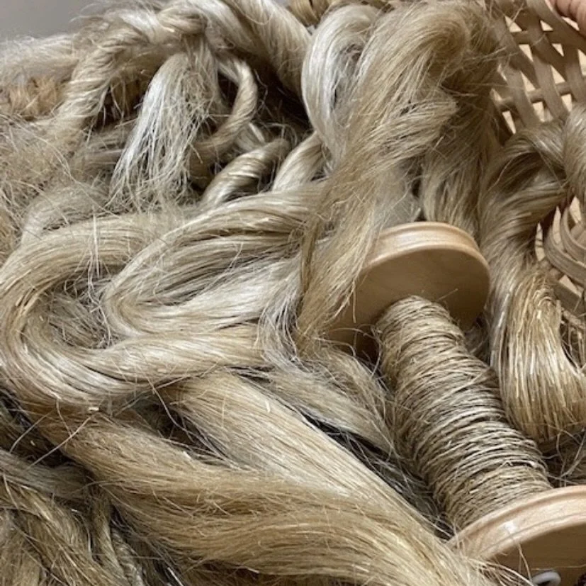 flax fiber and bobbin with spun flax yarn