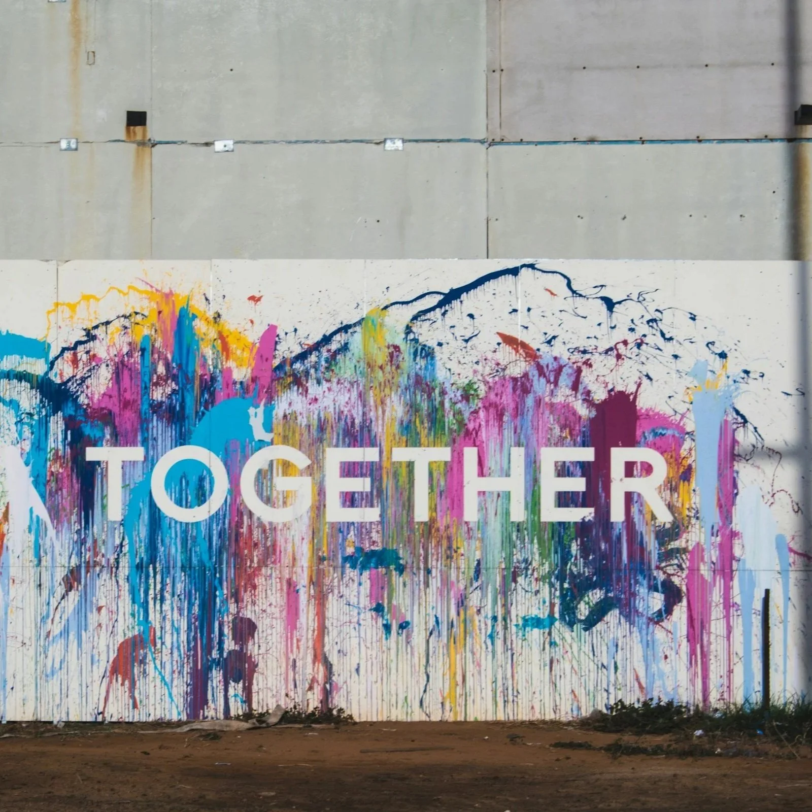 Mural on Wall with splashes of colorful paint and the word "Together"