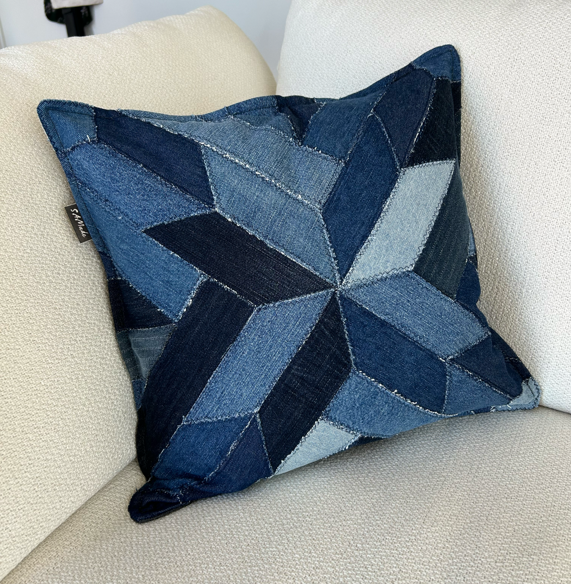 Throw cushion cover, upcycled denim and reclaimed blackout fabric. Insert filled with off-cut fabric remnants.