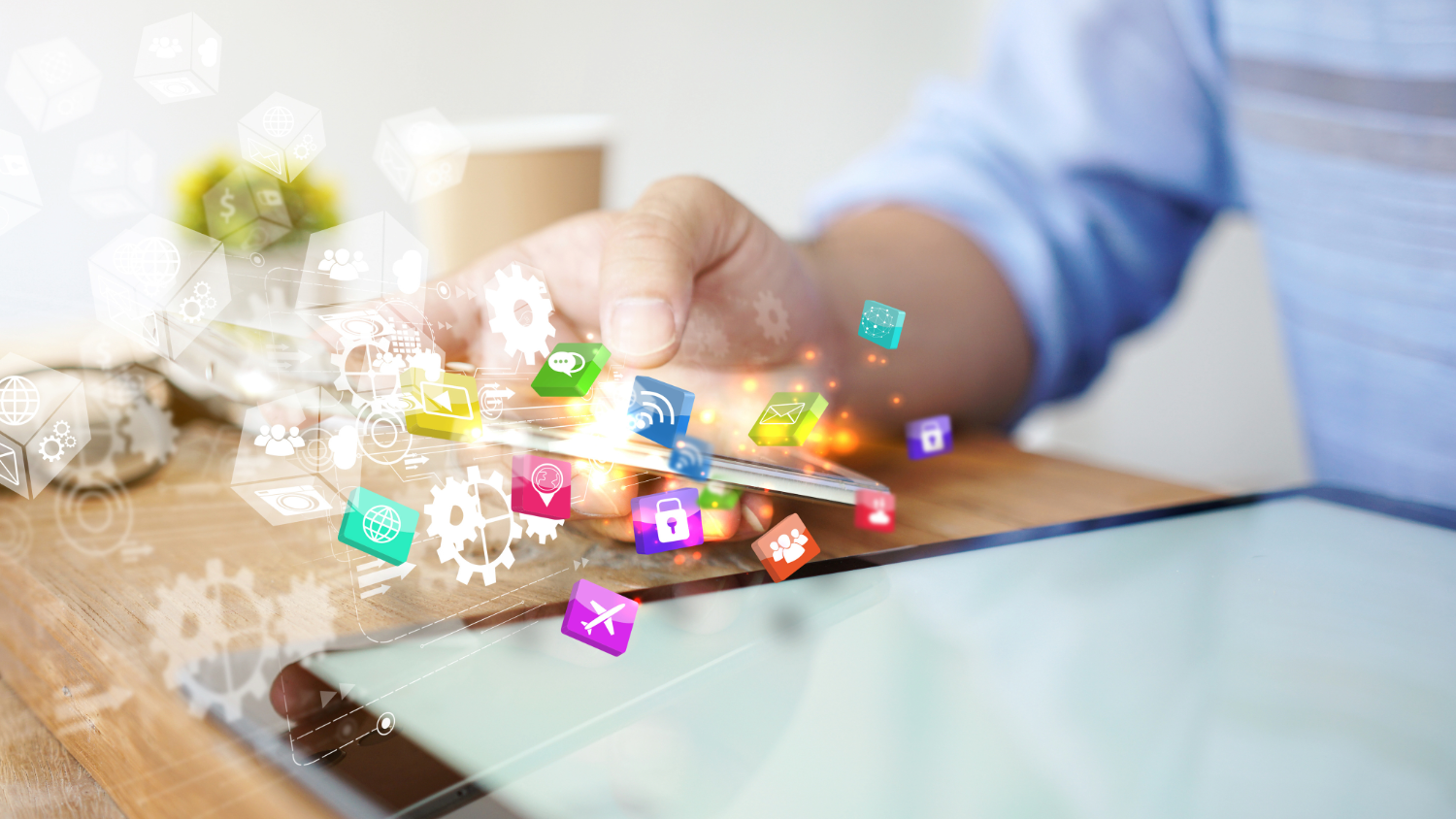 Person using a tablet with digital app icons and gears overlay for technology and app development.