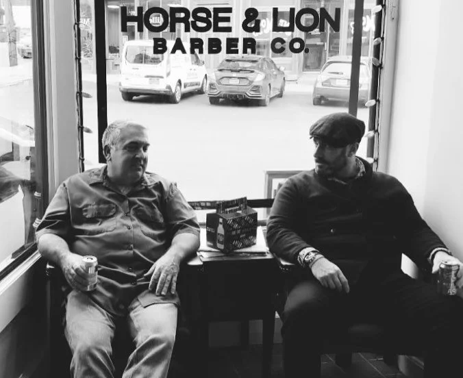Friends sitting in the waiting chairs at Horse and Lion Barber Co.