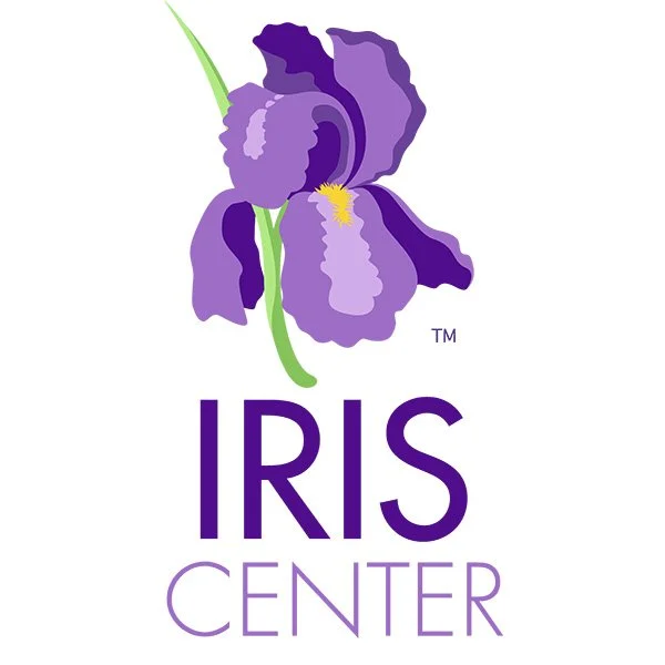 A purple iris flower with yellow center above the text "IRIS CENTER" in purple and lavender letters.