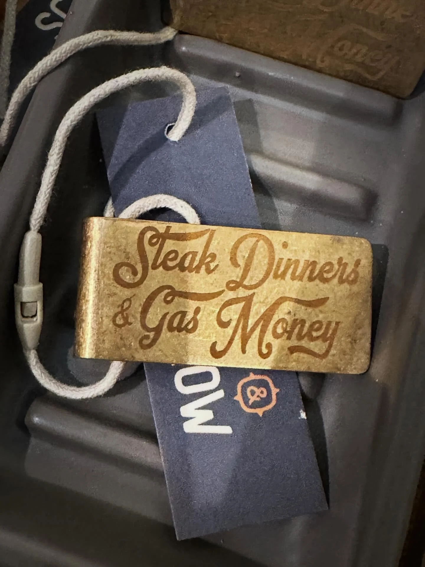 A solid brass money clip stamped &ldquo;Steak Dinners &amp; Gas Money&rdquo; &mdash; equal parts practical and personality. The kind of piece that feels like it&rsquo;s been around a while (in the best way) and only gets better with time.

Tuck it in