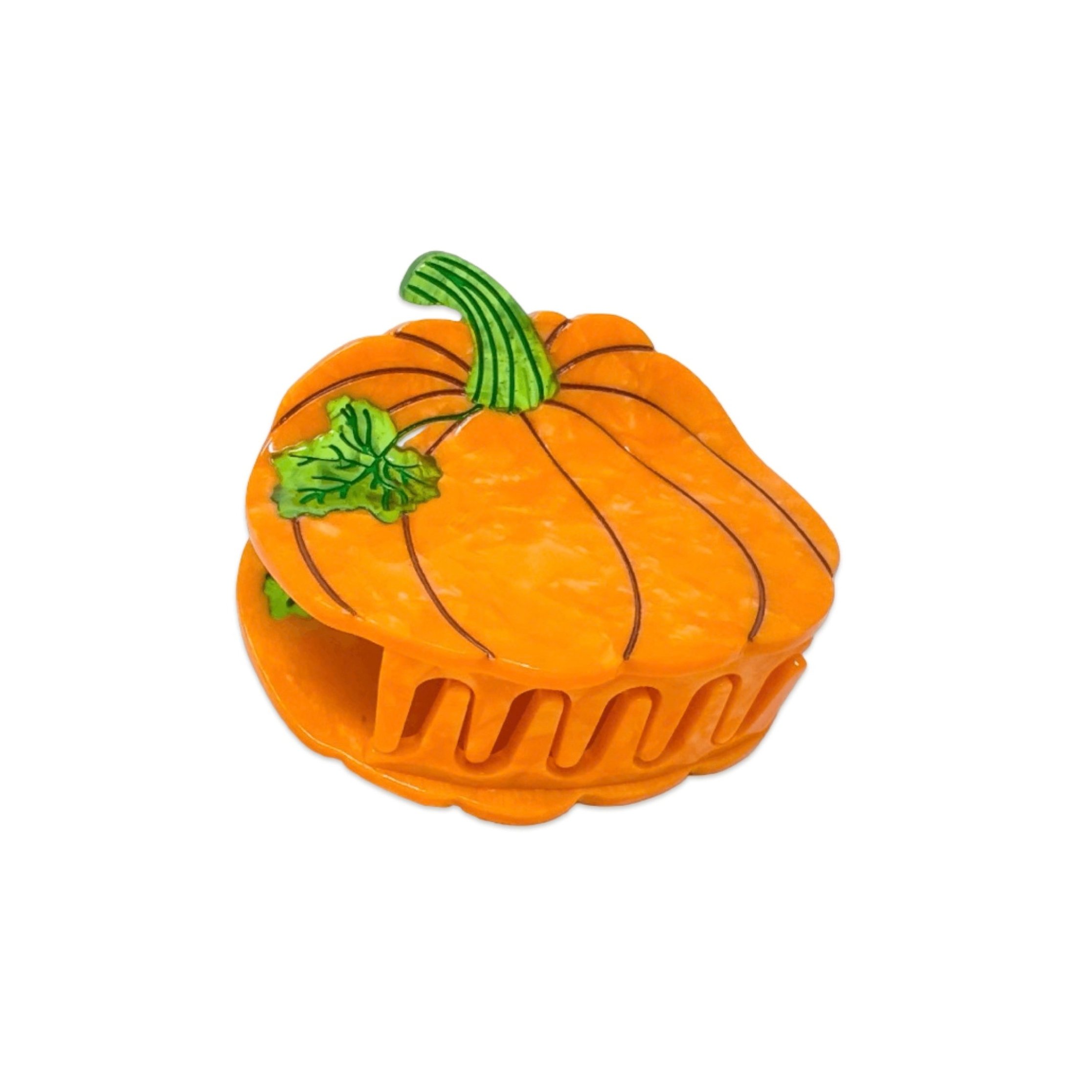 Close-up of orange pumpkin hair claw with green stem and leaf detail