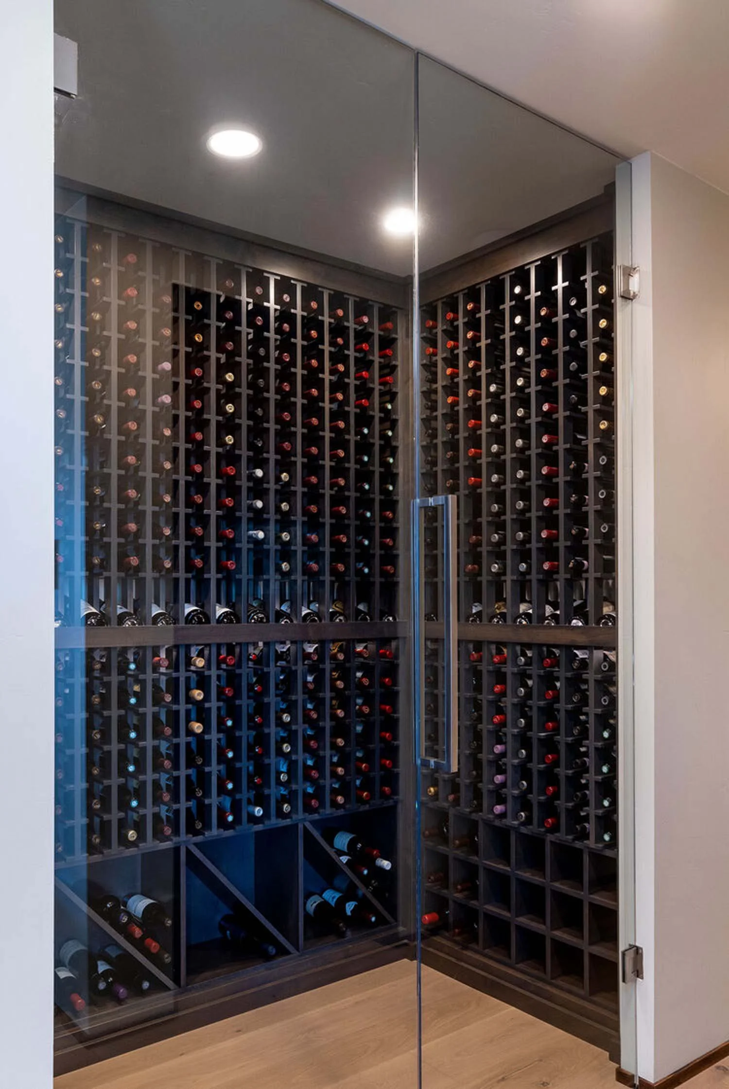 This custom home wine storage cabinet is a luxurious and functional addition to this Awbrey Butte residence. As a showcase of Pacwest Builders' expert construction and interior design, this cabinet features an elegant glass door and multiple shelves