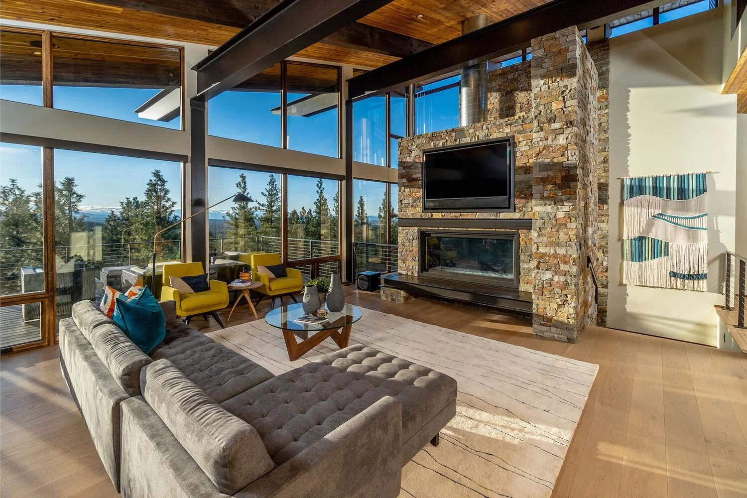 This gorgeous Great Room, a showcase of the masterful architecture of this Awbrey Butte - Starview residence, is the perfect example of a high-end residential custom home in Central Oregon. The exposed steel structure and a wall of floor-to-ceiling S
