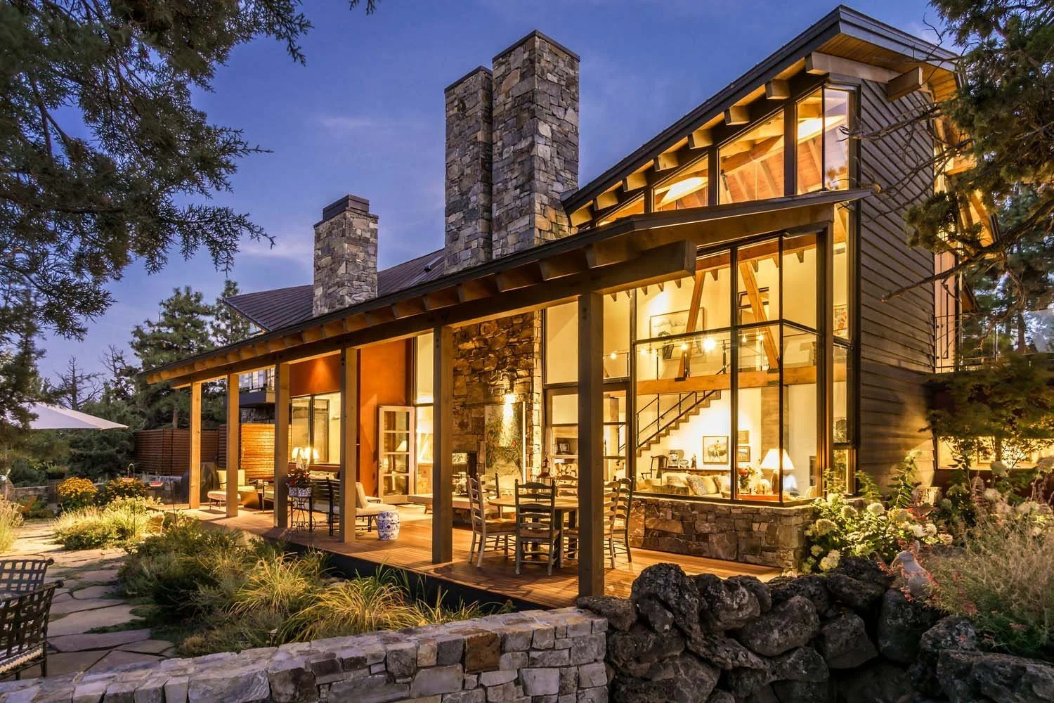 Experience the architectural grandeur of this large modern home in North Rim - Puccoon Court, a luxury custom home expertly built by Pacwest Builders with Hayes Inc. design. Floor-to-ceiling windows and a commanding stone chimney. A spacious patio an