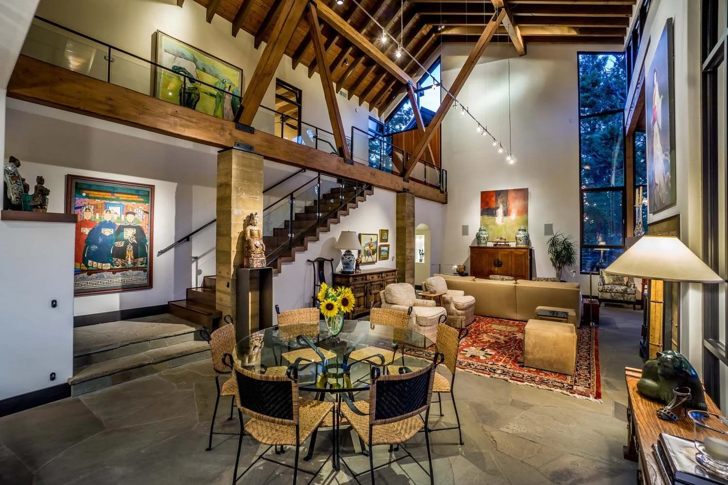Step into the impressive interior of this spacious modern living room, a highlight of luxury custom homes built by Pacwest Builders with Hayes Inc. design in North Rim. Soaring high ceilings and prominent wooden beams define the expansive space, comp