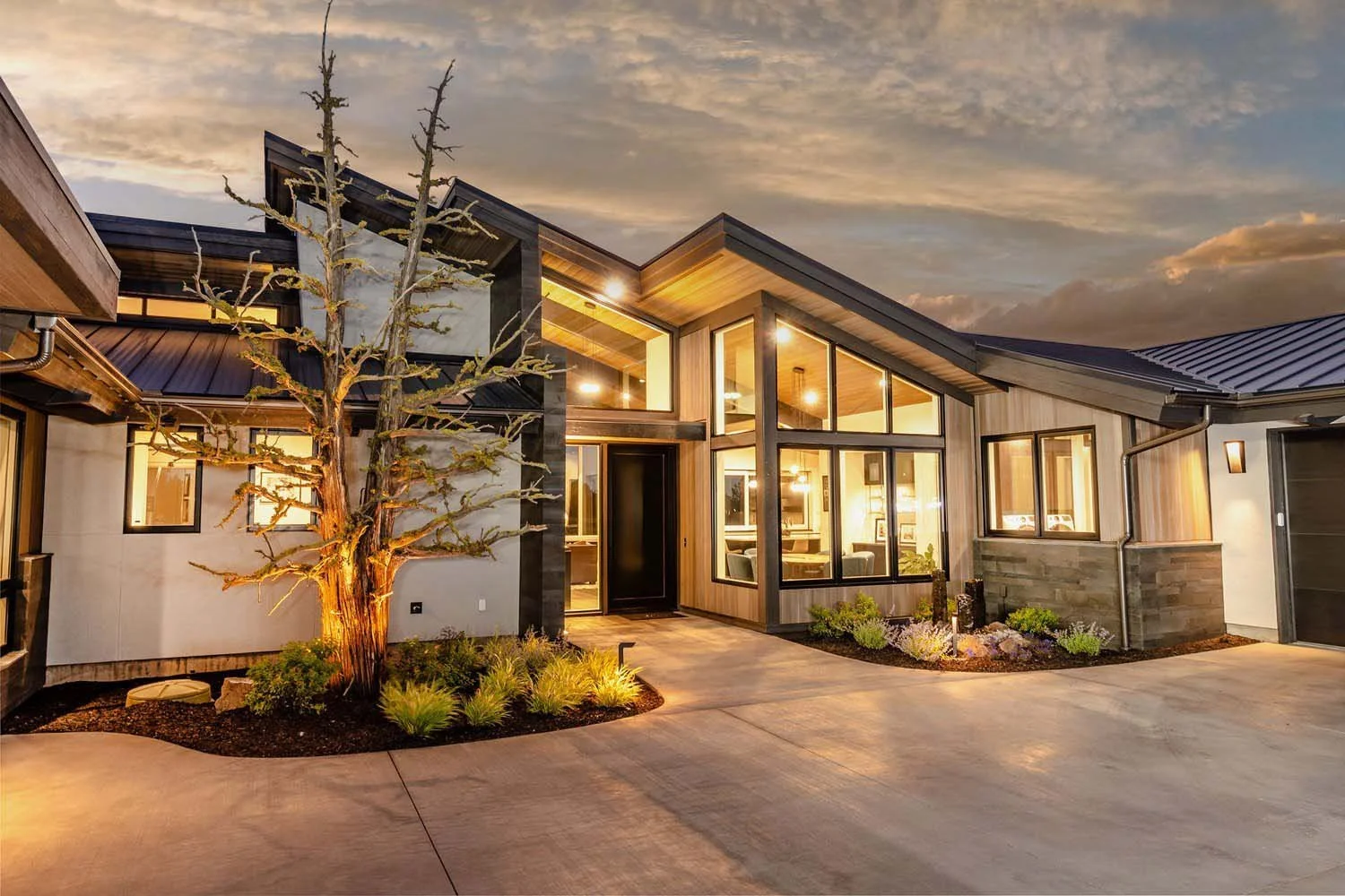 The impressive front yard of the Pronghorn - Canyon View home, designed by Blair Davis, is a perfect introduction to its unique architecture. This mountain modern home features a striking and dramatic angled structure that creates a sense of unity an